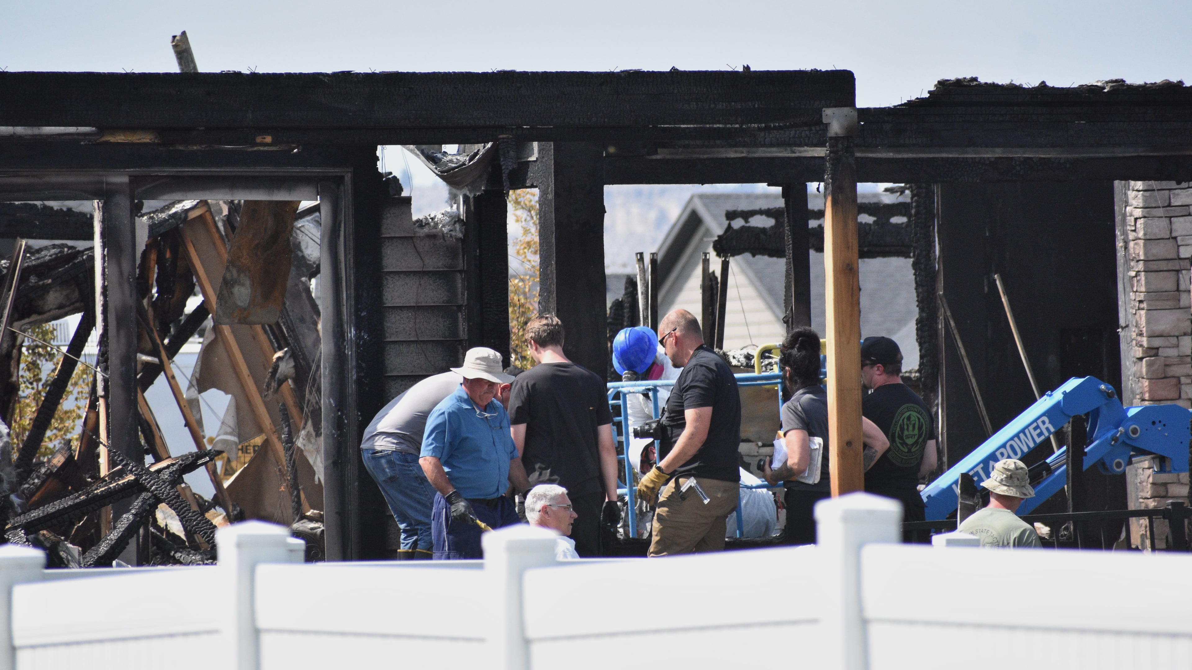 Investigators work at the scene Tuesday, Aug. 25, 2026, where a family was killed and the house burned in Billings, Mont. (AP Photo/Matthew Brown)