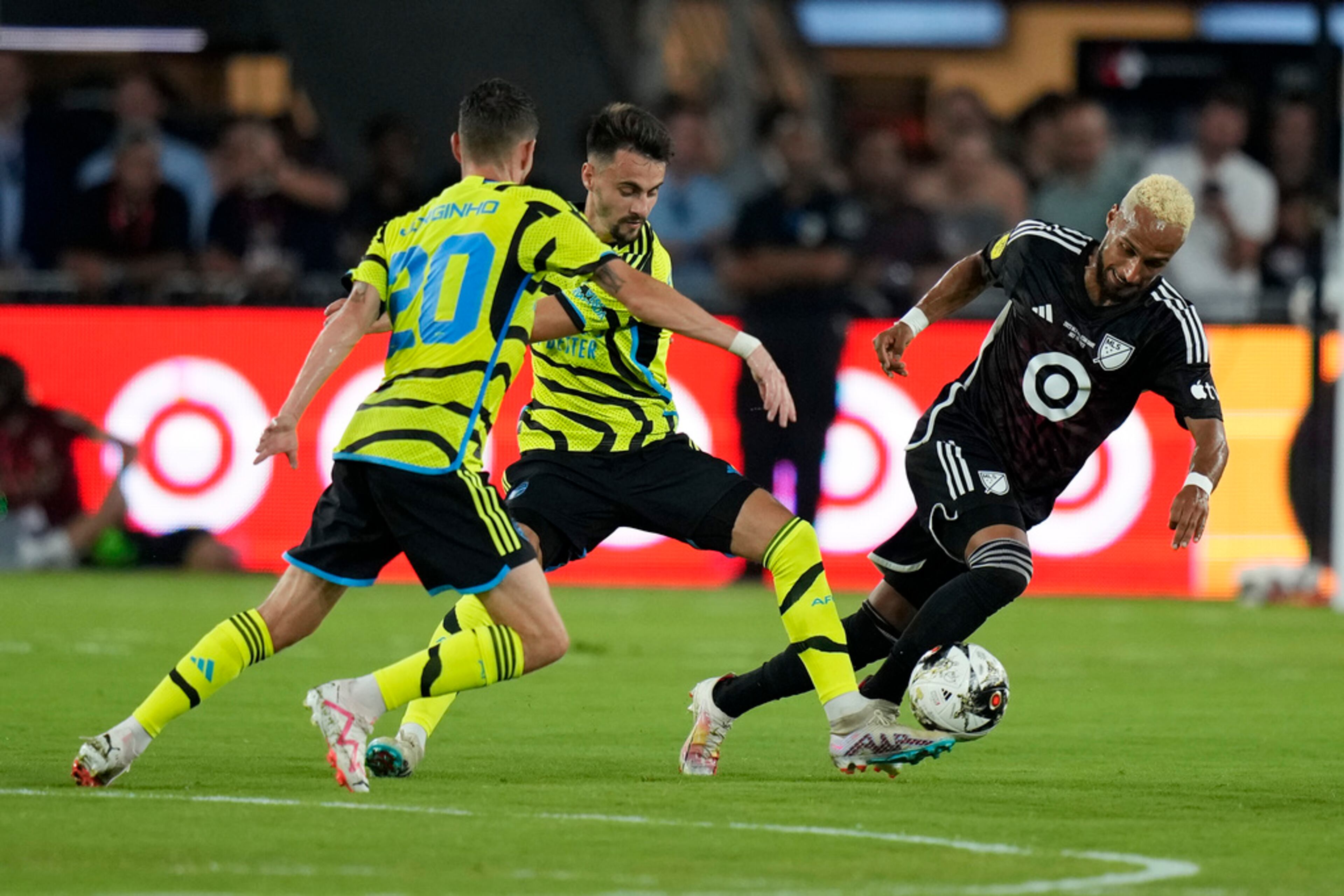 Nashville SC midfielder Hany Mukhtar, right, drives the ball past Arsenal midfielders Jorginho, left, and Fábio Vieira in the first half of the MLS All-Star soccer match, Wednesday, July 19, 2023, in Washington. (AP Photo/Alex Brandon)