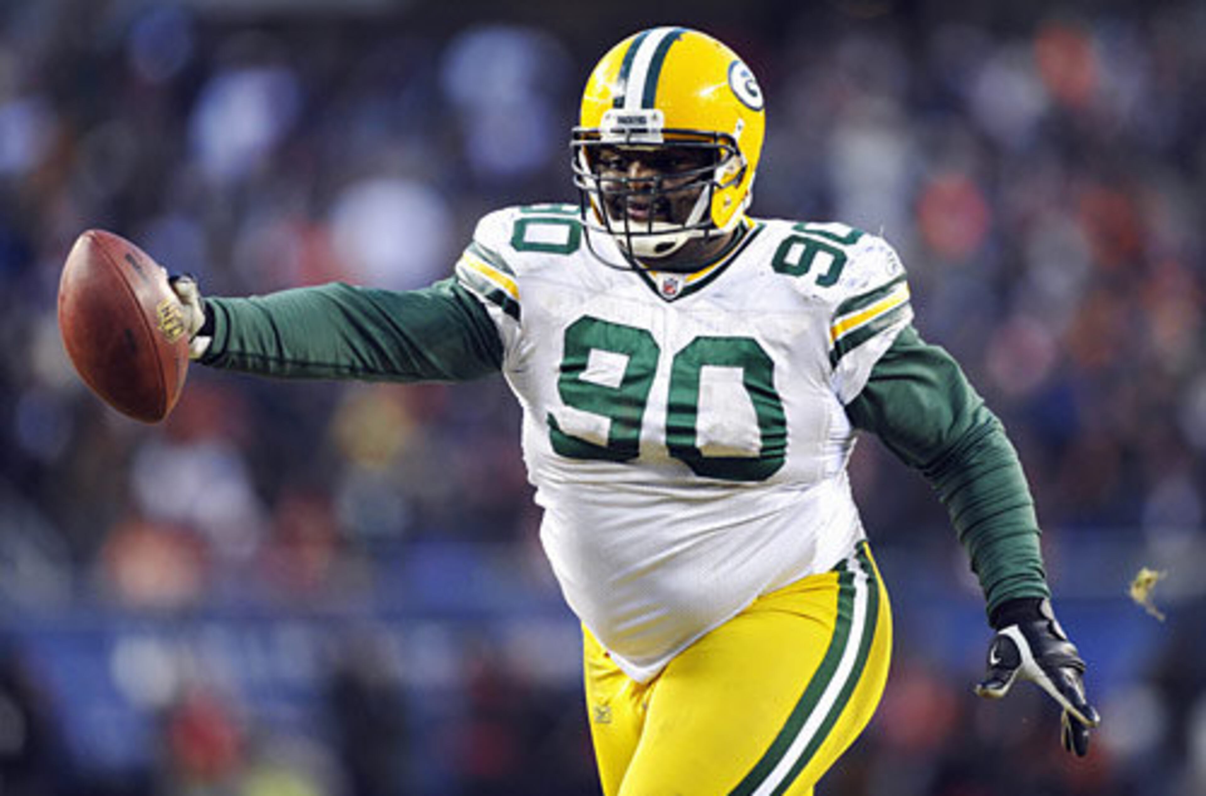 Packers defensive tackle B.J. Raji (90) reacts after intercepting and running the ball back for a touchdown against the Chicago Bears during the second half of the NFC Championship. Despite a late Bears rally, the Packers took the NFC title 21-14, earning a trip to Super Bowl XLV.
