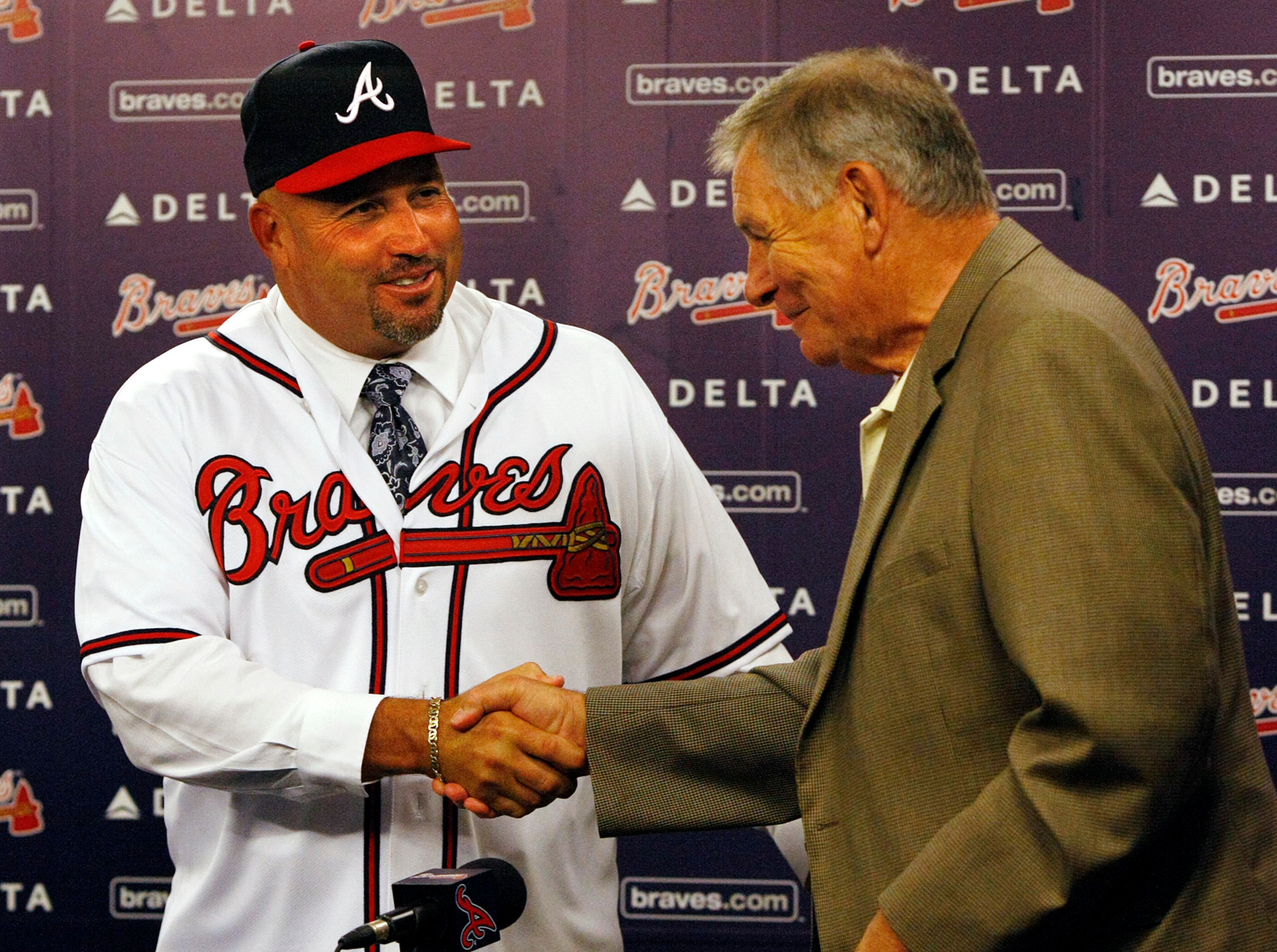 Coming and going handshake: New Braves manager Fredi Gonzalez shakes hands with the man he is following as skipper, Bobby Cox, in 2010.