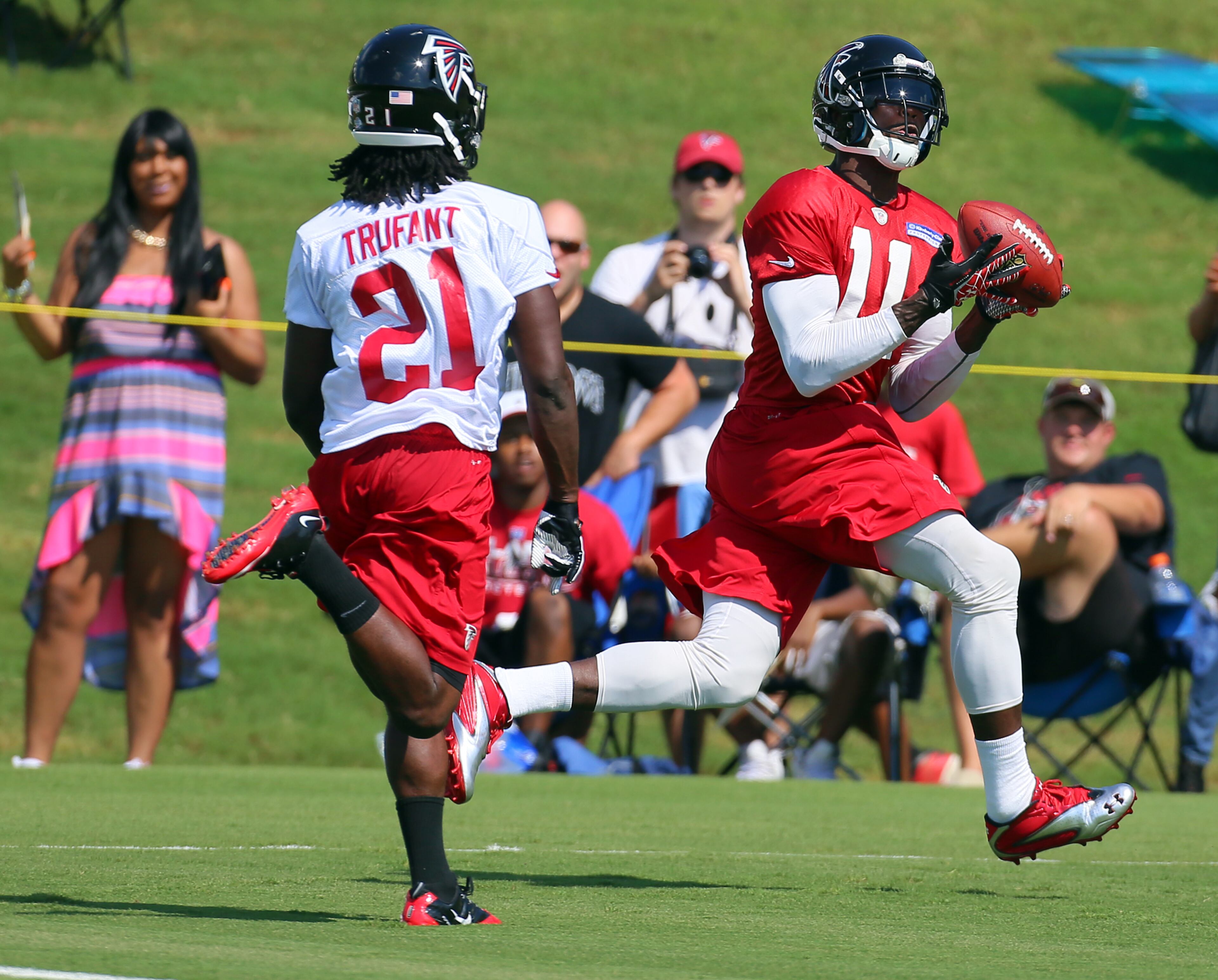 Falcons wide receiver Julio Jones schools rookie cornerback Desmond Trufant, hauling in a touchdown pass at training camp on Thursday, July 25, 2013, in Flowery Branch.