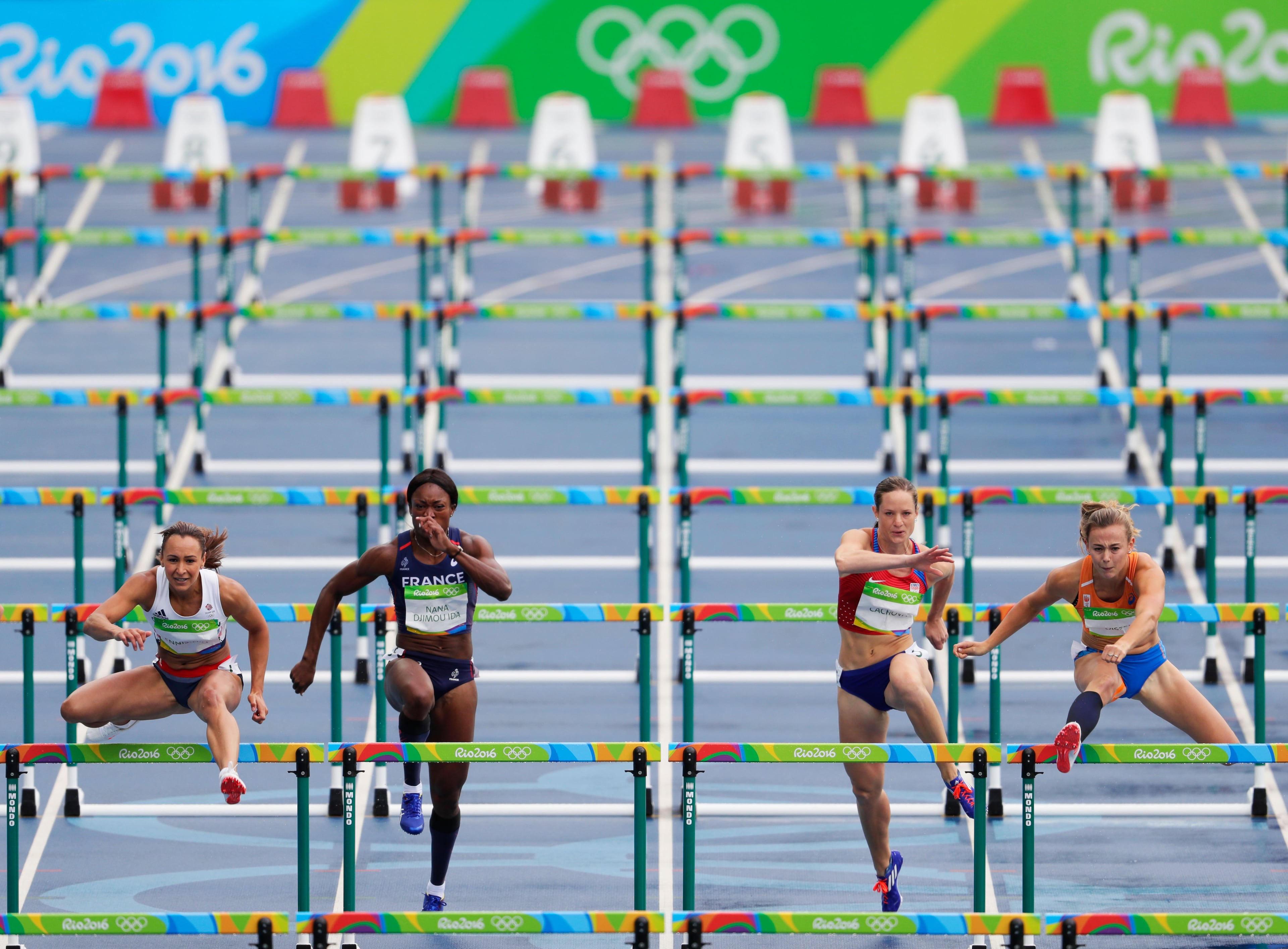 RIO DE JANEIRO, BRAZIL - AUGUST 12: Jessica Ennis-Hill of Great Britain, Antoinette Nana Djimou Ida of France, Katerina Cachova of the Czech Republic and Nadine Visser of the Netherlands compete in the Women's Heptathlon 100 Meter Hurdles on Day 7 of the Rio 2016 Olympic Games at the Olympic Stadium on August 12, 2016 in Rio de Janeiro, Brazil. (Photo by Jamie Squire/Getty Images)