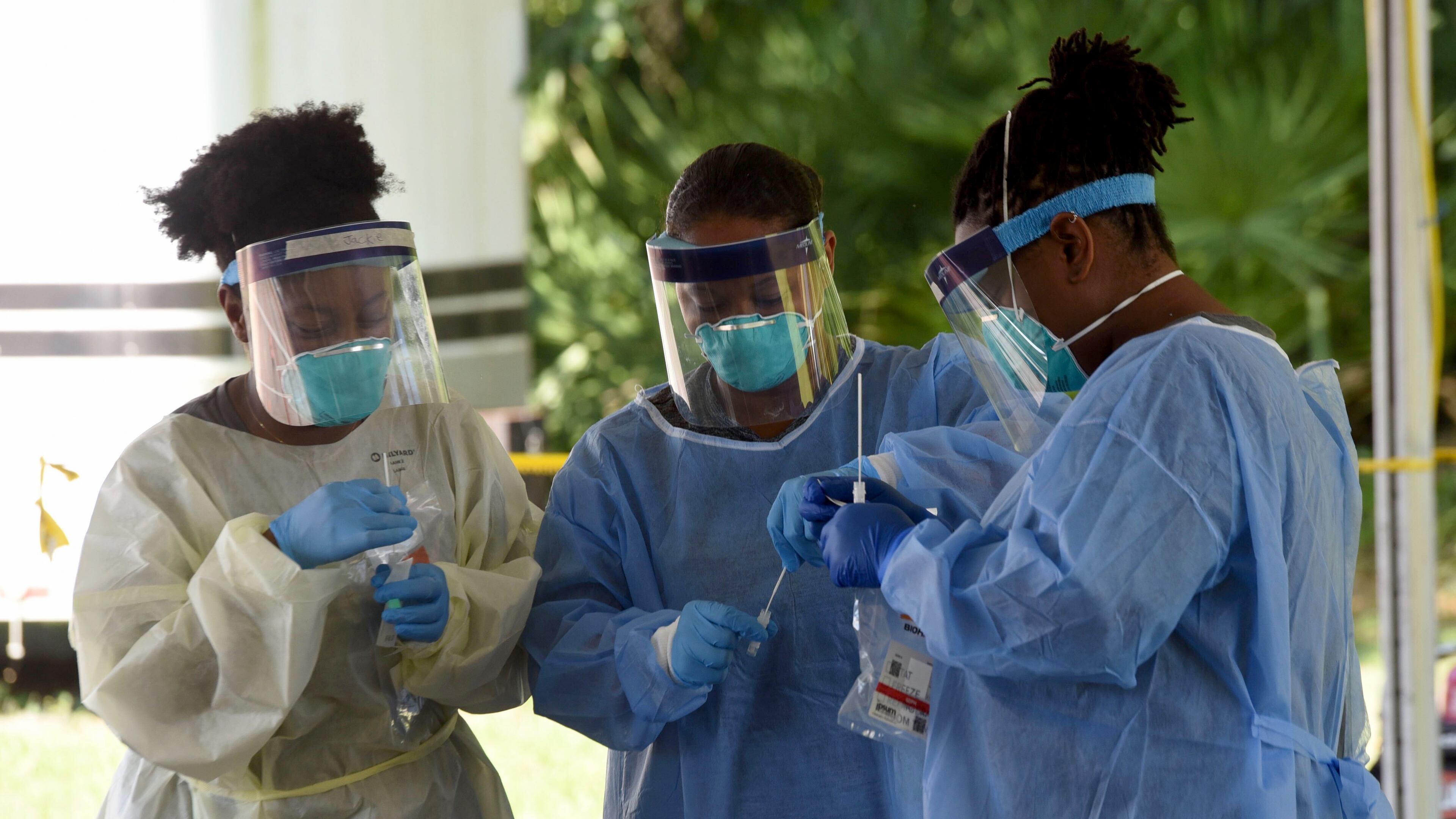 (From left to right) Jacqueline Jones, LPN, Sasha Stewart, RN, and Jesslyn Lewis, RN, secure COVID-19 tests outside the Glynn County Health Department in Brunswick. Ryon Horne/RHORNE@AJC.COM