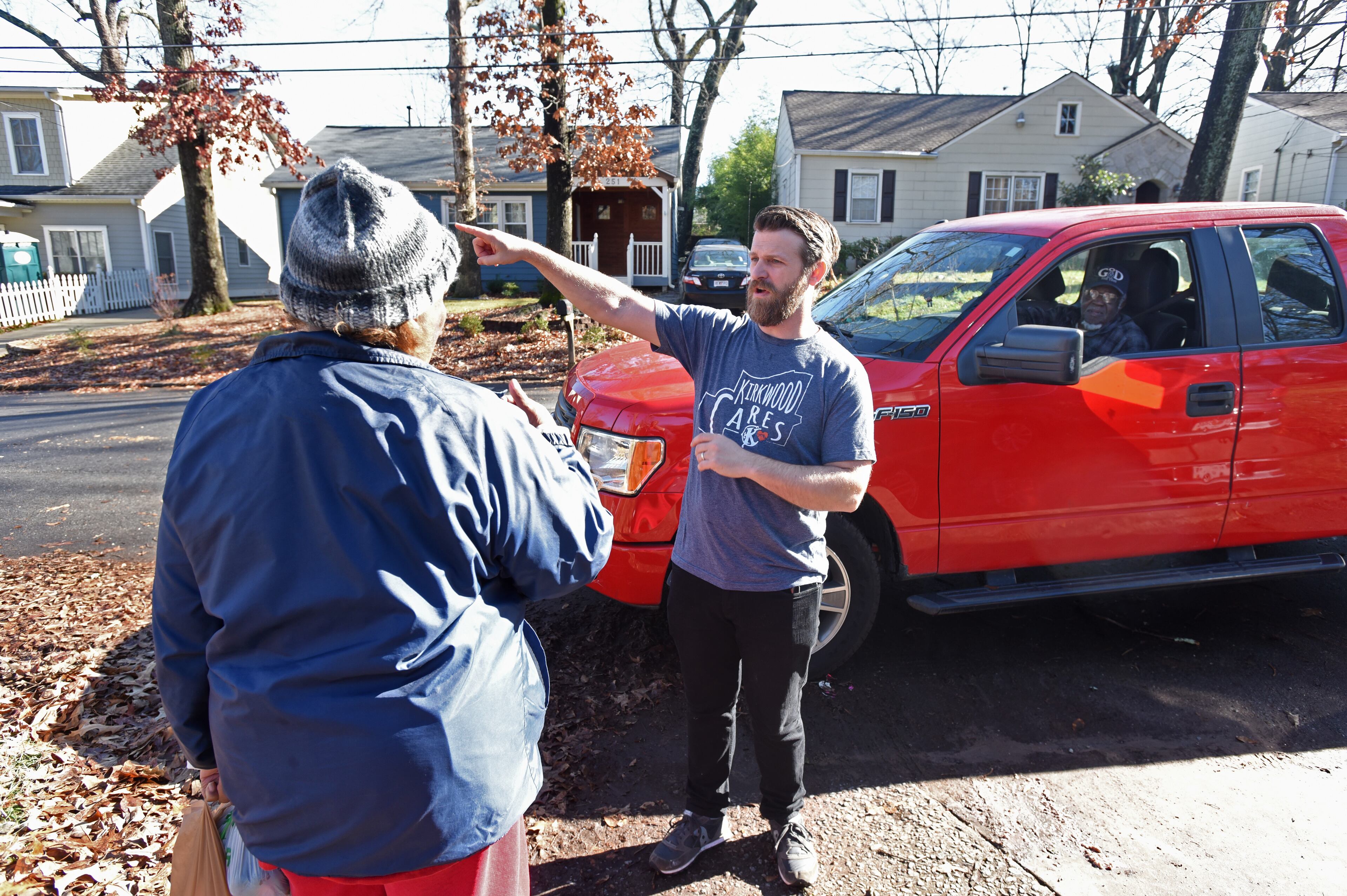 Ida James (left) explains her repair needs to Justin Schaeffer (center) as Woodrow Williams (right) looks from her truck in Kirkwood neighborhood. Schaeffer helps run an organization called Kirkwood Cares. (Hyosub Shin / Hyosub.Shin@ajc.com)