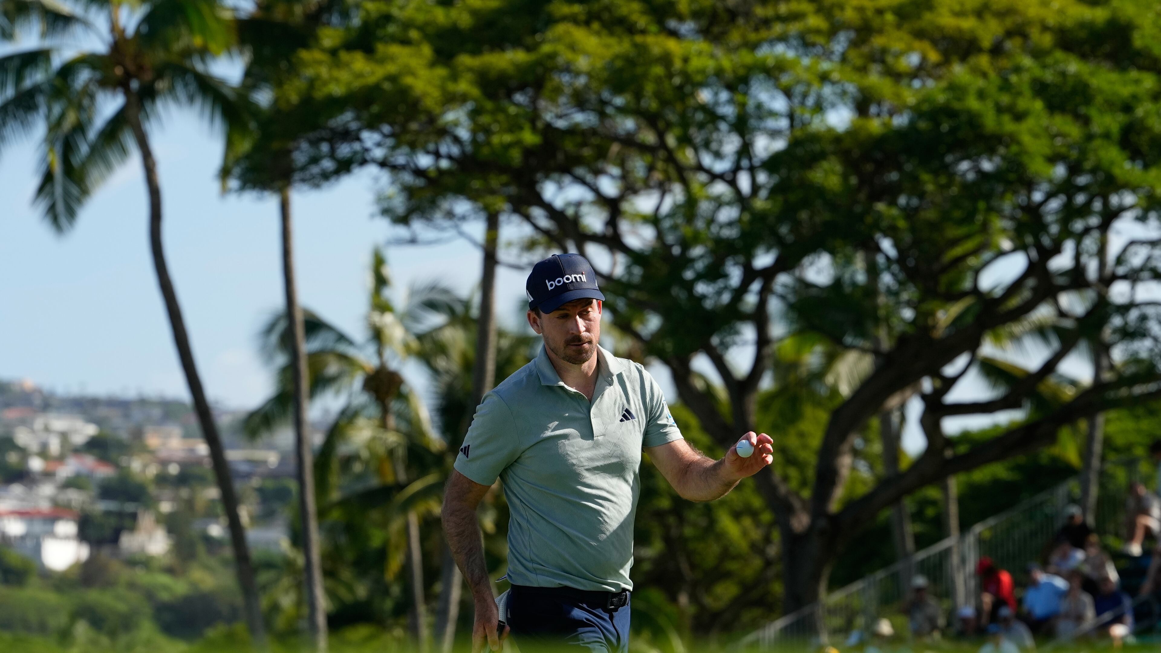 Nick Taylor, of Canada, reacts on the 18tyh hole during the first round of the Sony Open golf event at the Waialae Country Club in Honolulu, Thursday, Jan. 15, 2026. (AP Photo/Matt York)