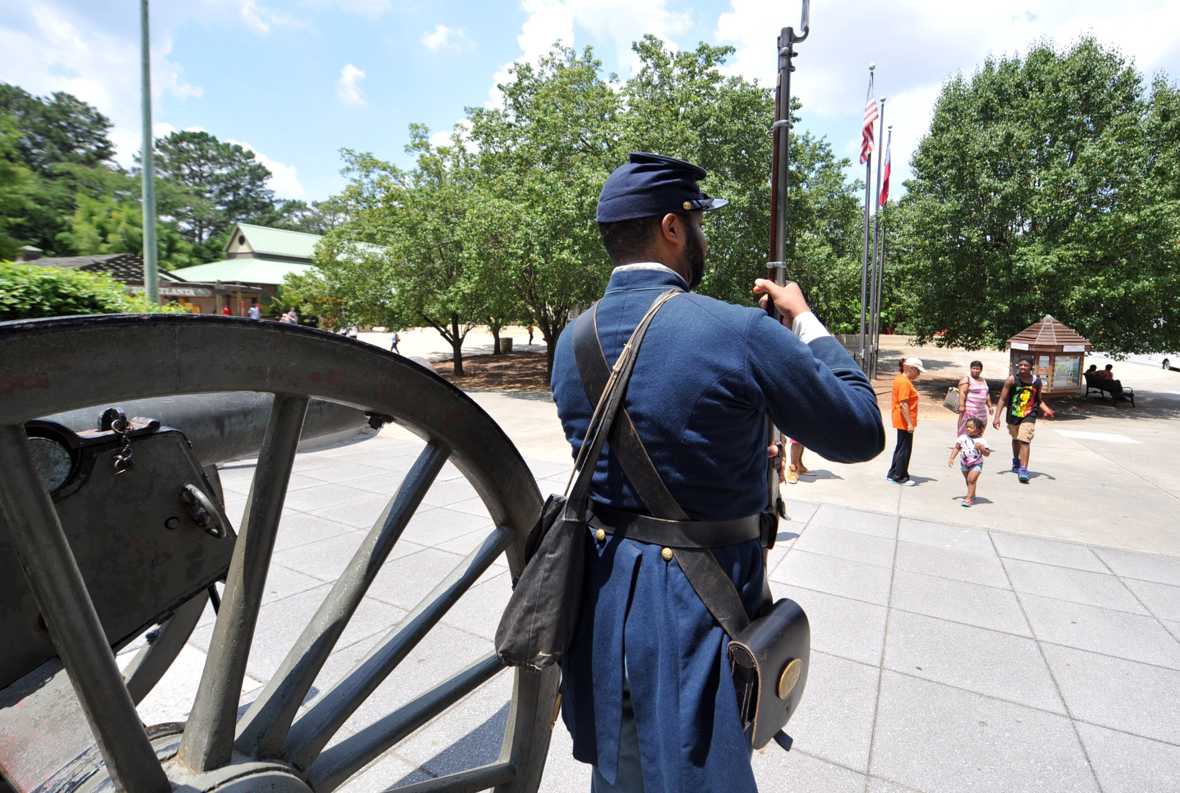 Re-enactor Marvin-Alonzo Greer stands post by a cannon outside during a Juneteenth celebration at the Atlanta Cyclorama and Civil War Museum, Friday, June 20, 2014. KENT D. JOHNSON/KDJOHNSON@AJC.COM