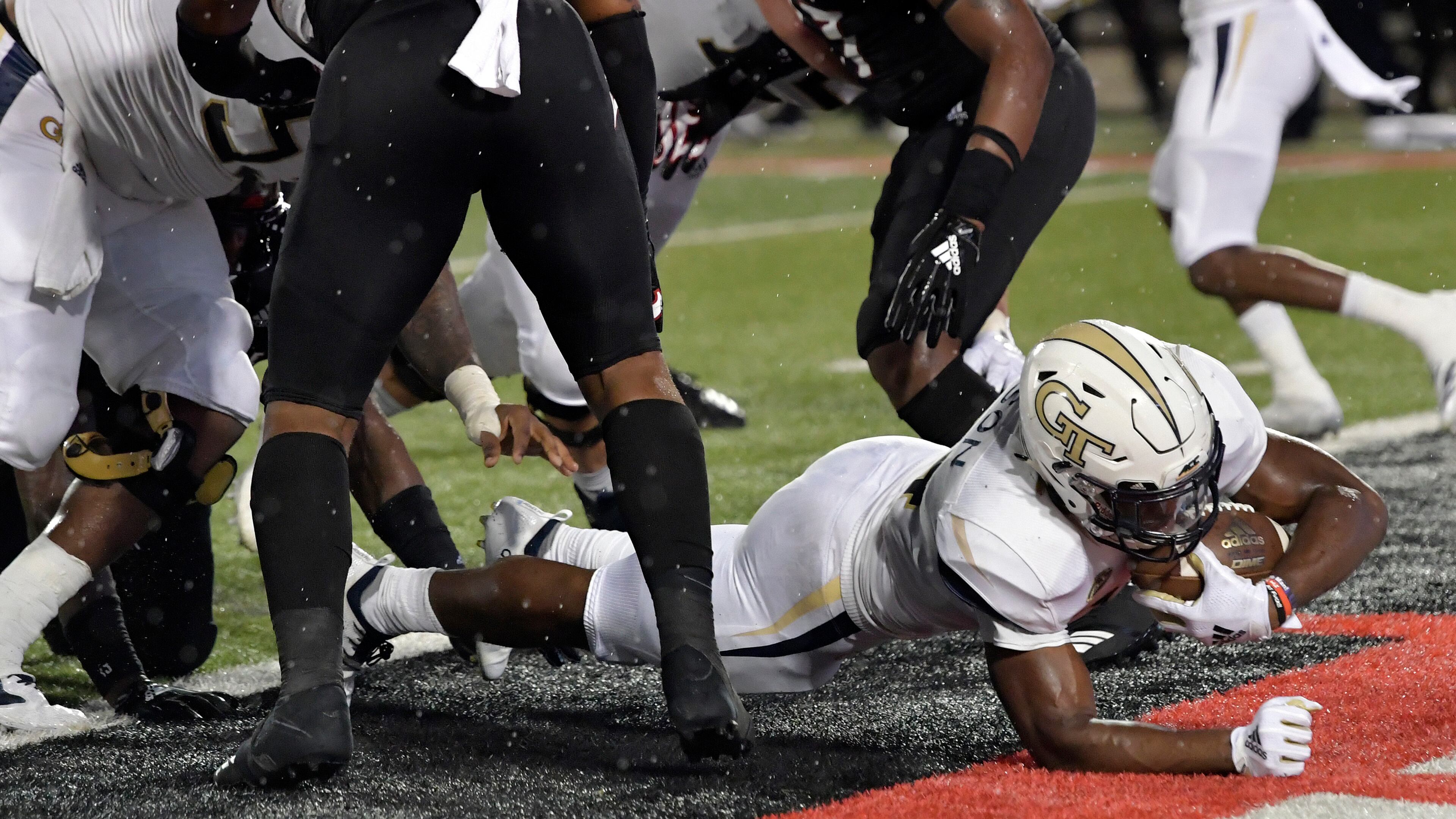 Georgia Tech running back Jordan Mason (24) busts through the Louisville line to score a touchdown during the first half of an NCAA college football game, Friday, Oct. 5, 2018, in Louisville, Ky. (AP Photo/Timothy D. Easley)