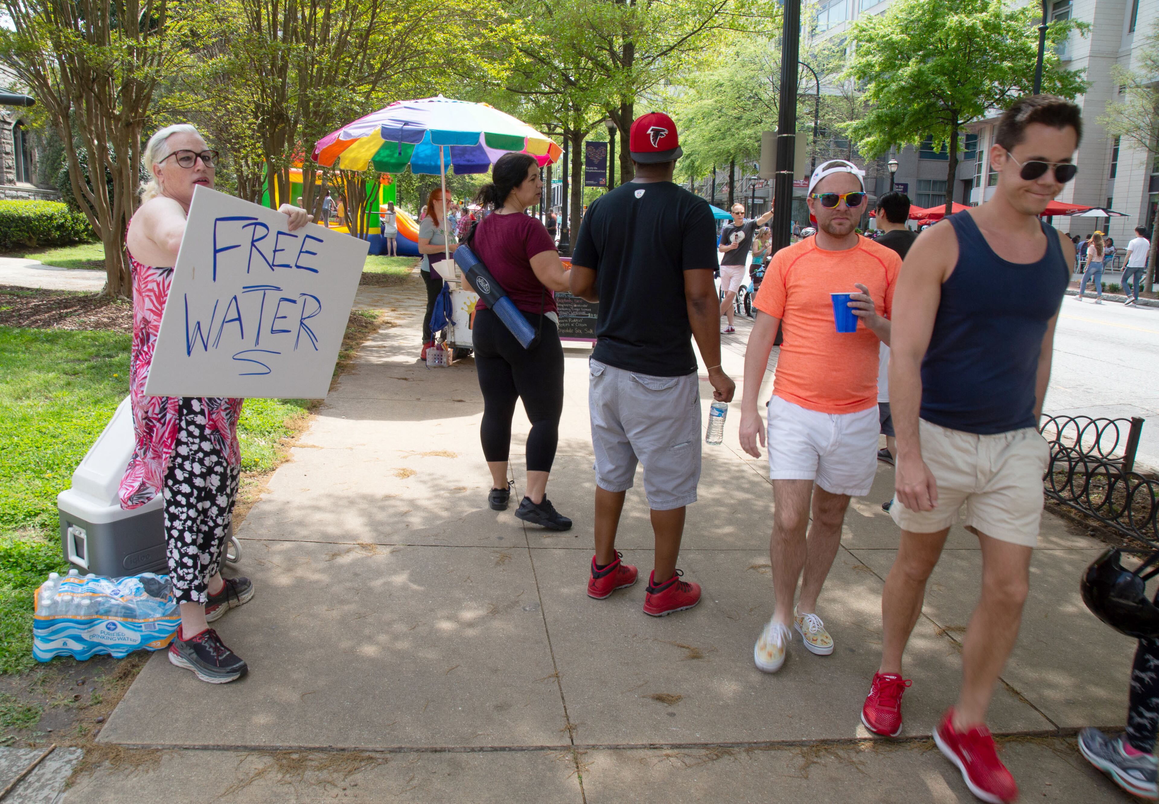 Christy Lynn hands out free water in front of the Saint Mark United Methodist Church during the Atlanta Streets Alive on Sunday, April 7, 2019. STEVE SCHAEFER / SPECIAL TO THE AJC