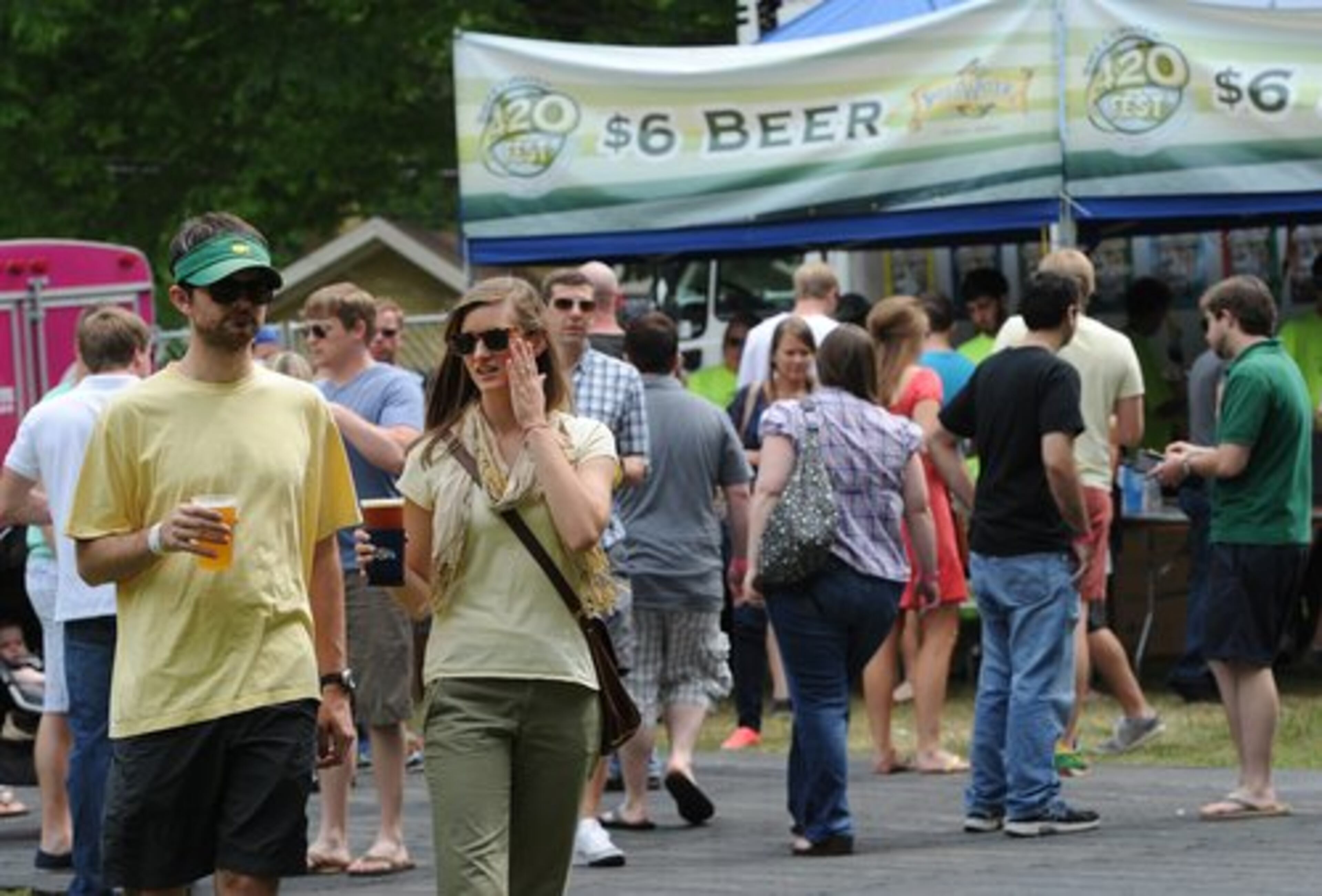 Festivalgoers walk and to and from the $6 beer vendors at the SweetWater 420 Fest at Candler Park on Saturday, April 21, 2012. Thousands of people listened to music, shopped, ate and drank beer during the three-day festival sponsored by Sweetwater Brewery in Atlanta.