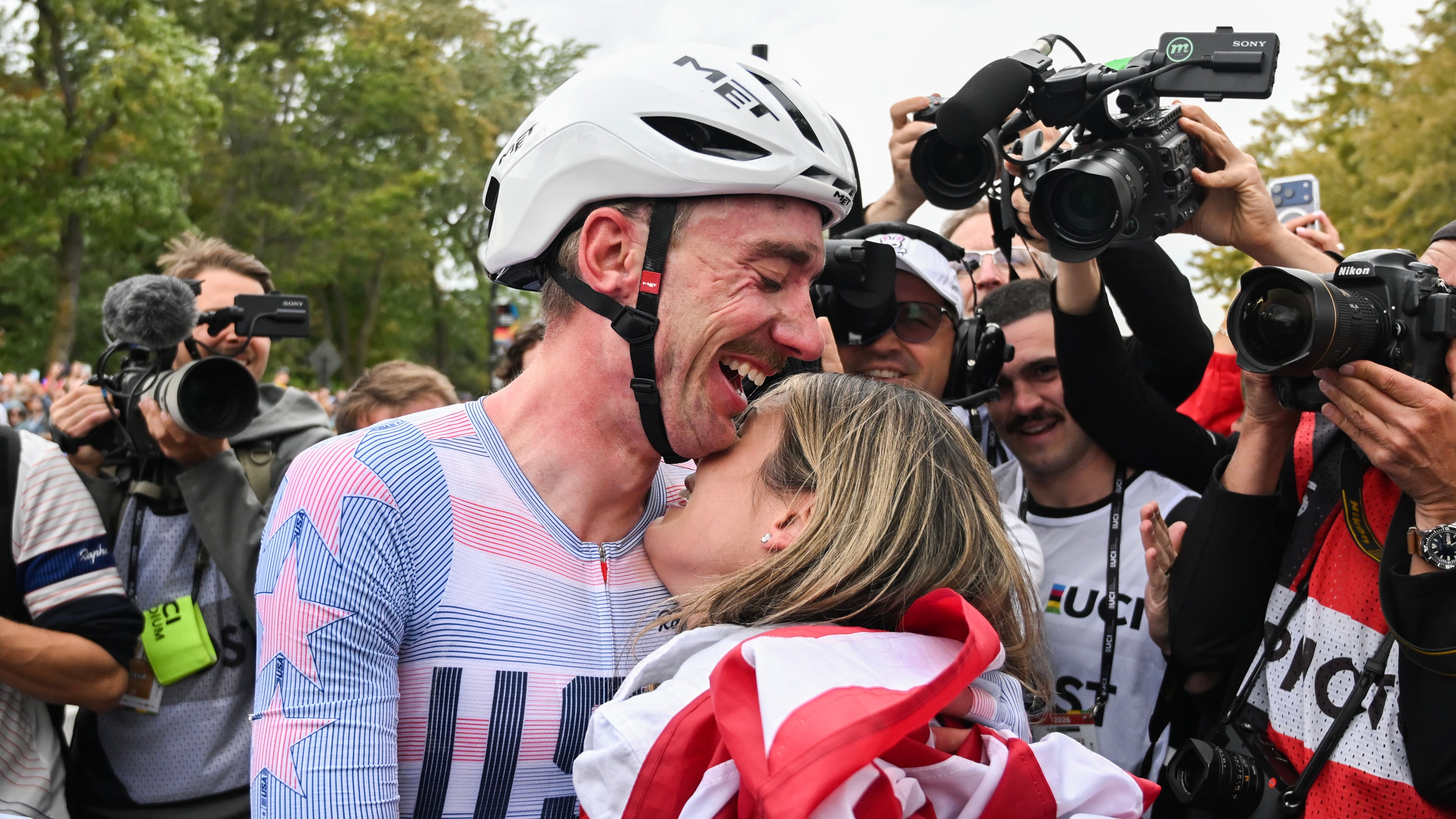 Brandon McNulty, of the United States, is hugged by his wife Summer after winning the men's elite road race at the UCI Road World Championships cycling event in Montreal on Sunday, Sept. 27, 2026. (Graham Hughes/The Canadian Press via AP)