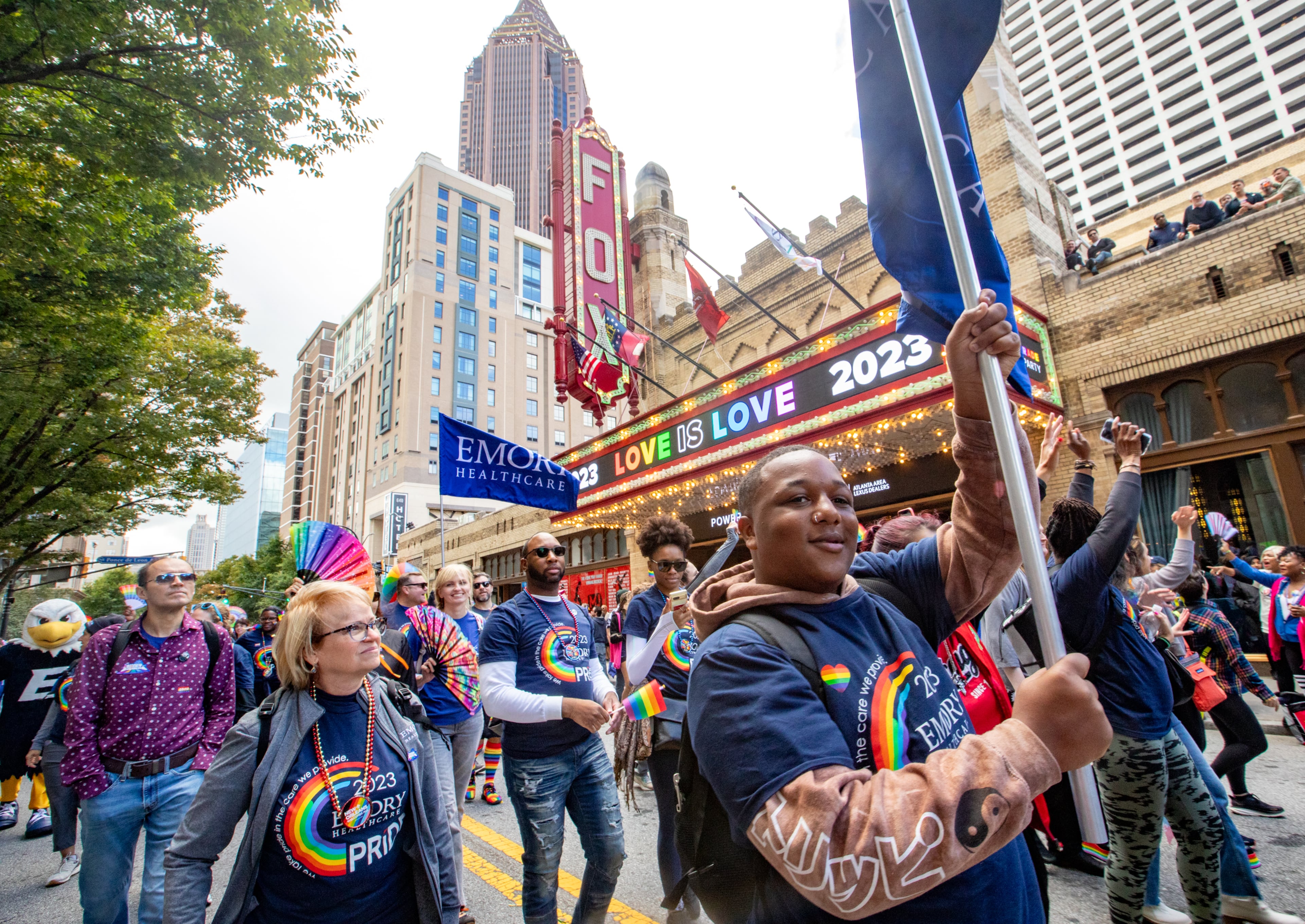 Rodreavious Sears, front right, marches with Emory in the annual Pride Parade in Atlanta on Sunday, Oct 15, 2023. (Jenni Girtman for The Atlanta Journal-Constitution)