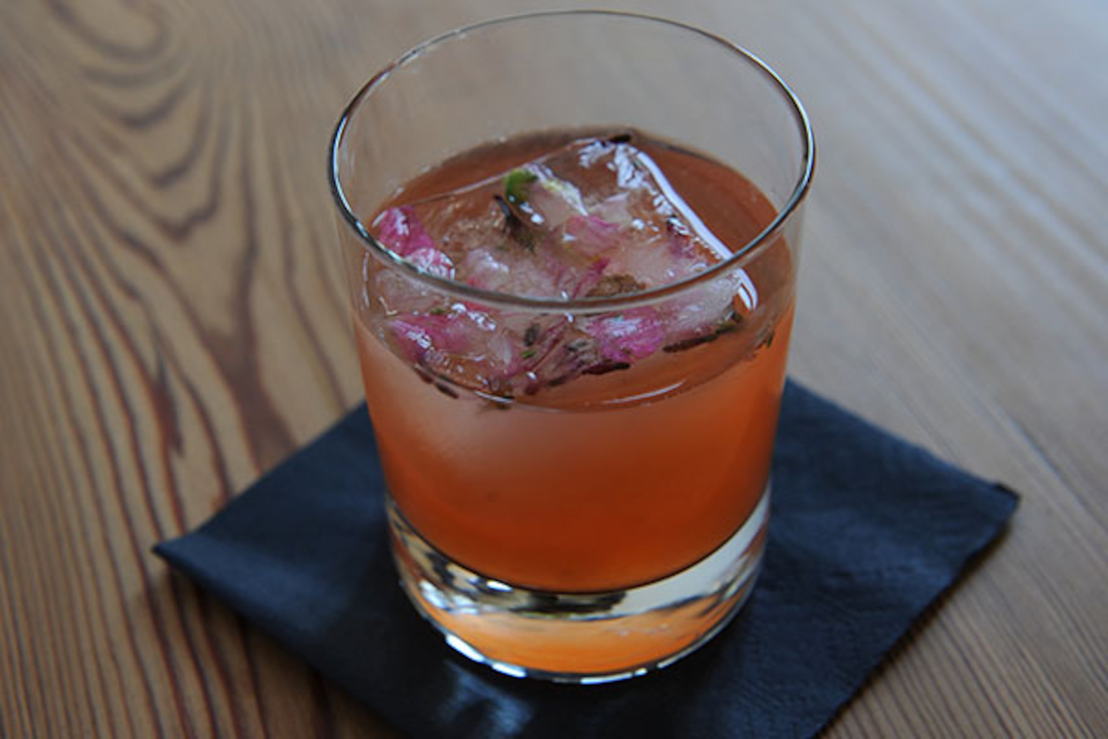 Time Invested- tequila, pear, Aperol, lemon, green tea and choice of celery or locally grown wildflowers in a single ice cube. (BeckySteinPhotography.com)