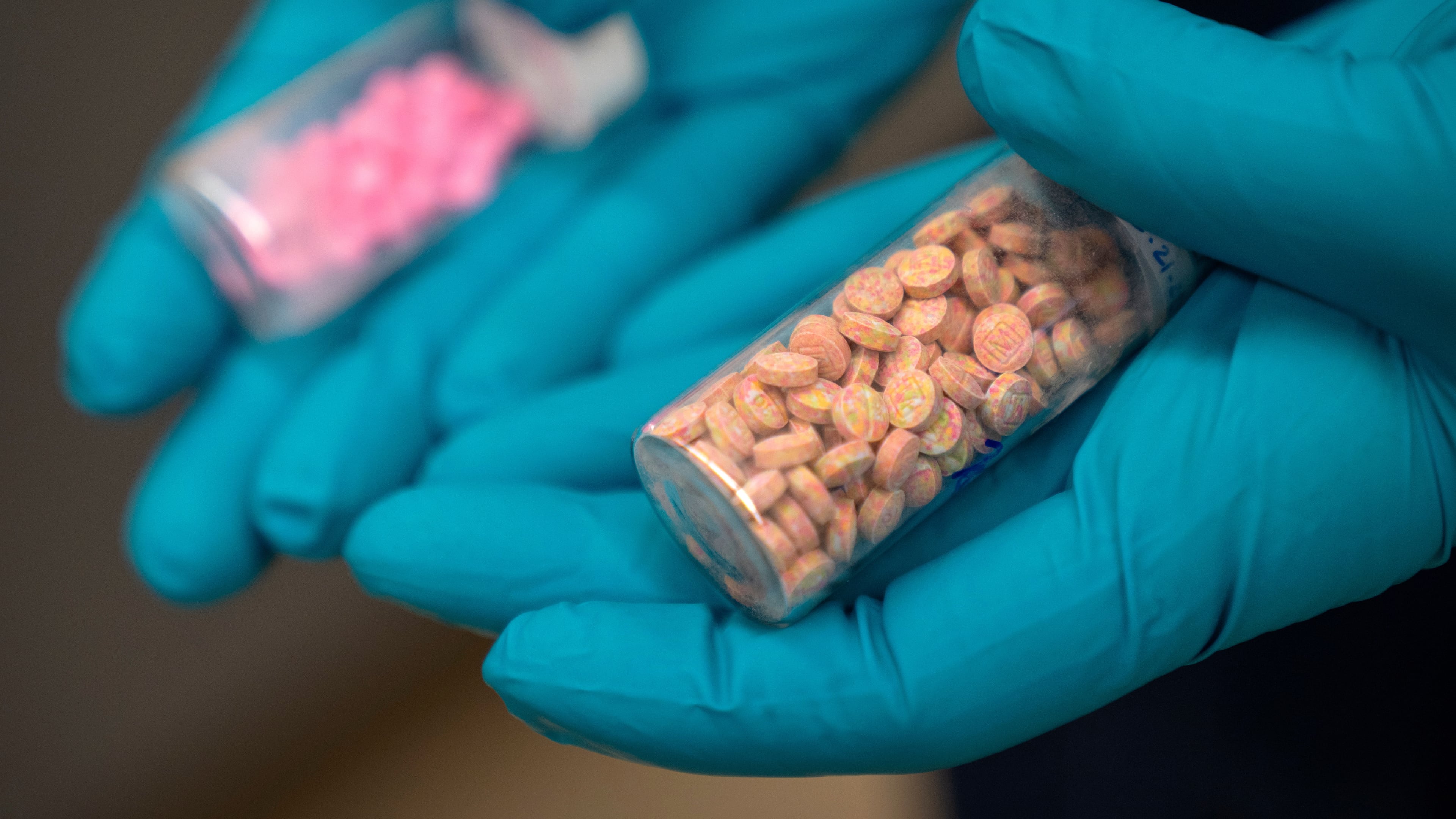 FILE - Jonathan Dumke, a senior forensic chemist with the Drug Enforcement Administration, holds vials of fentanyl pills at a DEA research laboratory on Tuesday, April 29, 2025, in Northern Virginia. (AP Photo/Mark Schiefelbein, file)