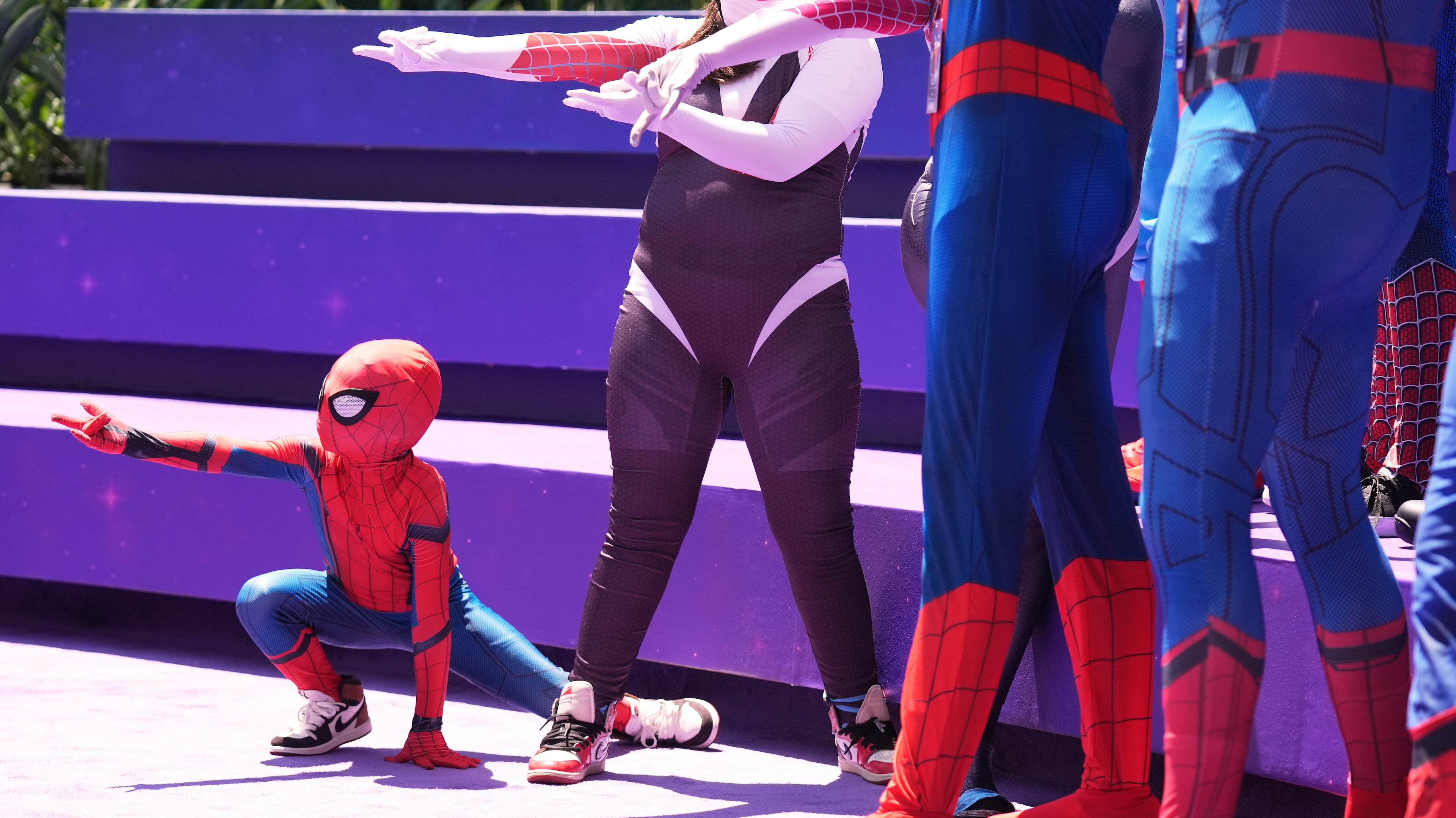 Daniel Delgado, 6, of Victorville, Calif., joins a photo op for cosplayers dressed as "Spider-Man" during D23: The Ultimate Disney Fan Event on Friday, Aug. 14, 2026, at the Anaheim Convention Center in Anaheim, Calif. (Chris Pizzello/AP)