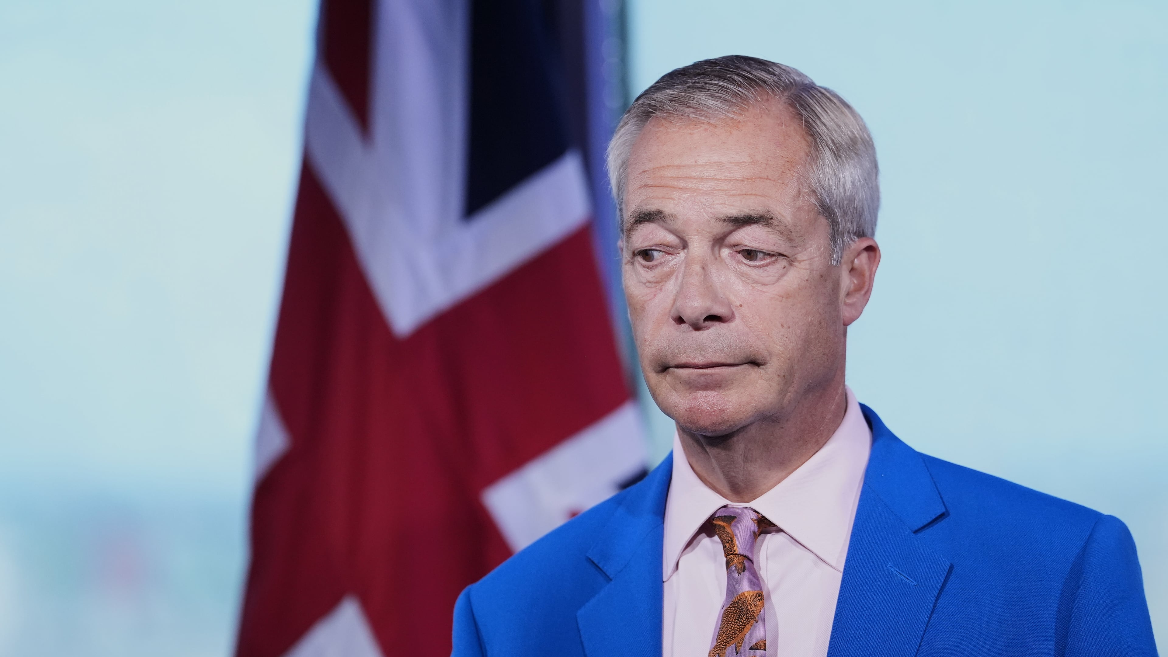 Reform UK leader Nigel Farage looks on as he makes a statement to the media at the party headquarters in Millbank, central London, Tuesday July 7, 2026. (Gareth Fuller/PA via AP)