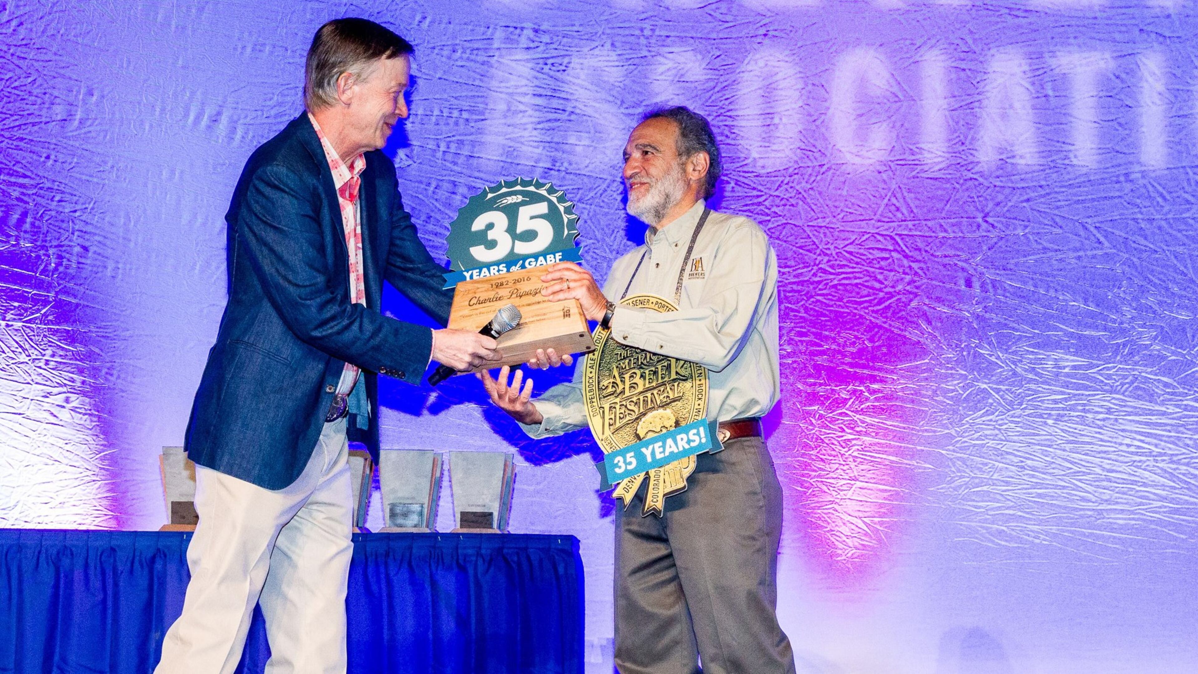 Colorado Governor John Hickenlooper honored Great American Beer Festival founder Charlie Papazian at the 35th anniversary awards ceremony. PHOTO CREDIT: © 2016 Jason E. Kaplan