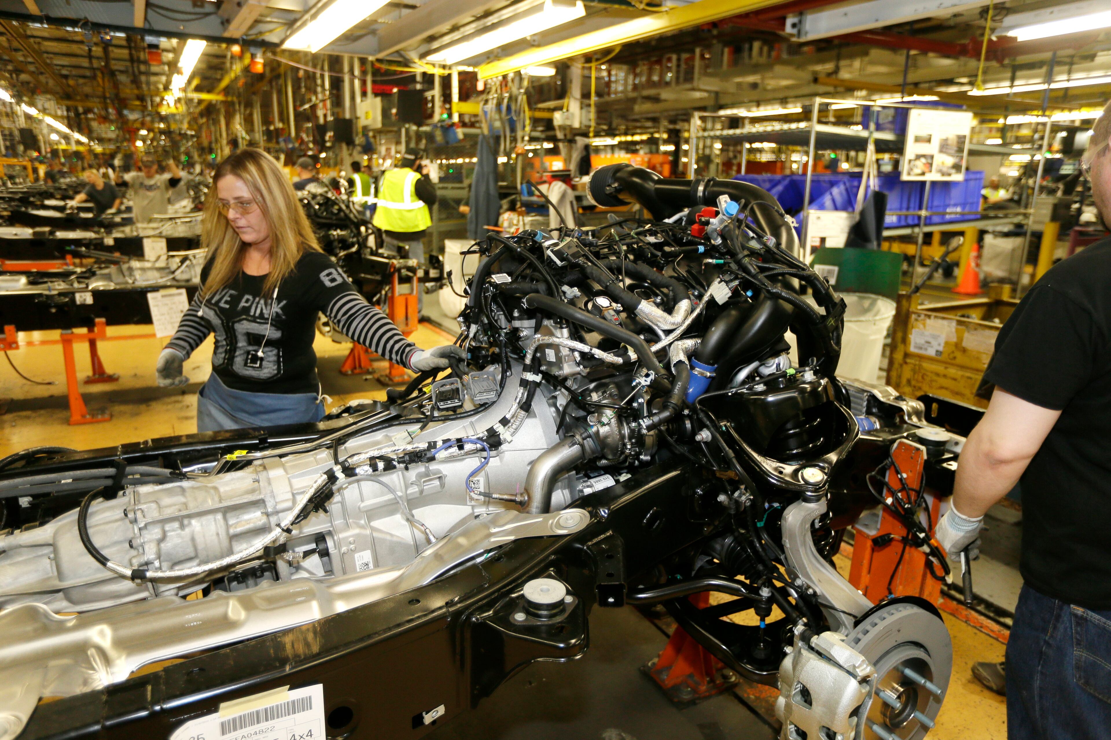 Jamie Winkles works on the brake line on the new Ford F-150 truck at the Rouge Truck Plant in Dearborn, Mich. It's the automaker's biggest bet in decades: an aluminum-sided F-150 that could set a new industry standard _ or cost the company its pickup truck crown. It will arrive on U.S. dealer lots next month. Aluminum _ which is lighter than steel but just as strong _ isn't new to the auto industry, but this is the first time it will cover the entire body of such a high-volume vehicle. (AP Photo/Carlos Osorio)