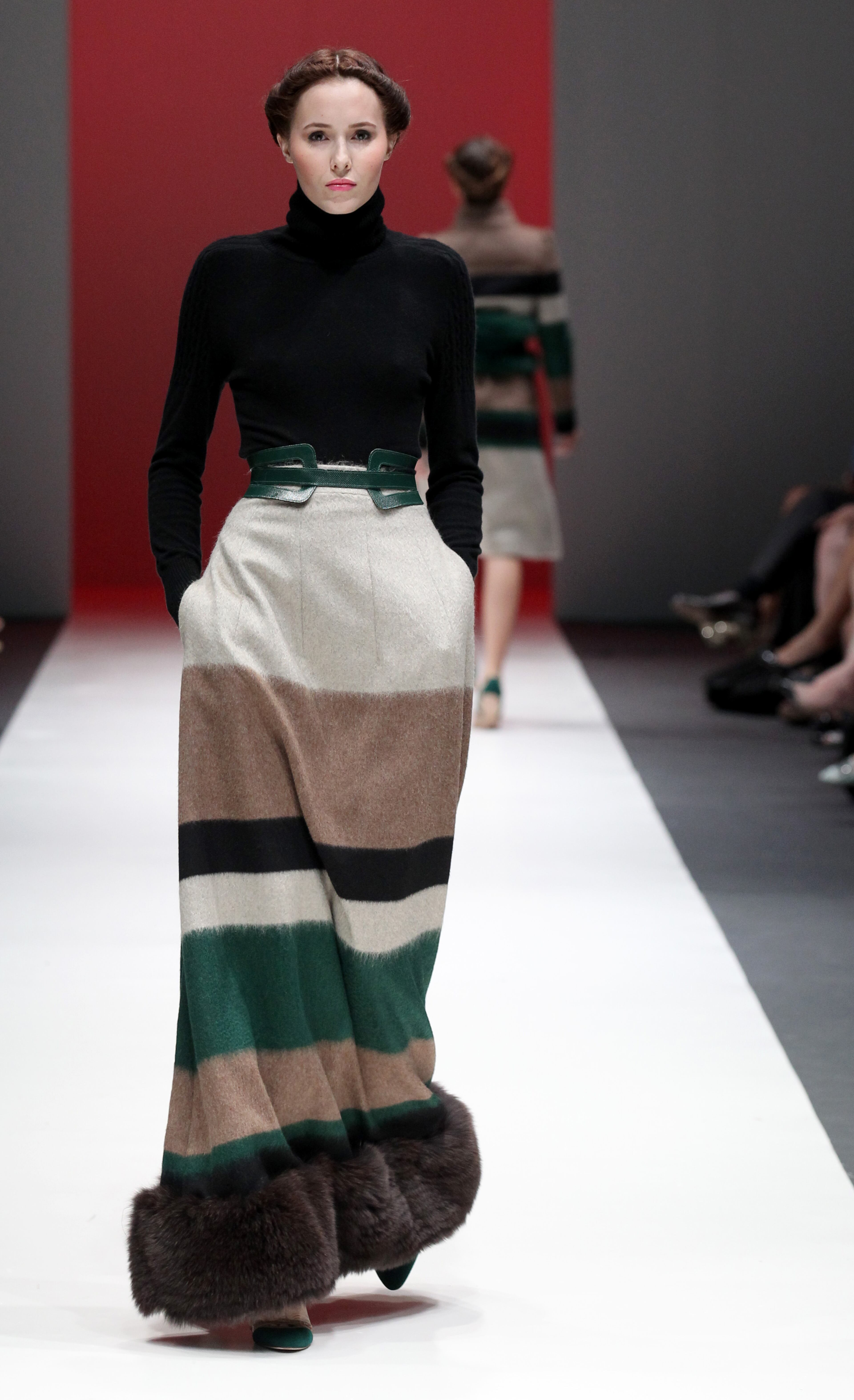 A model showcases an outfit by New York based designer Carolina Herrera for 'The House of Herrera' Fall 2013 collection, in Singapore, Wednesday, May 15, 2013, during the annual Fashion Festival held in the city-state. (AP Photo/Wong Maye-E)