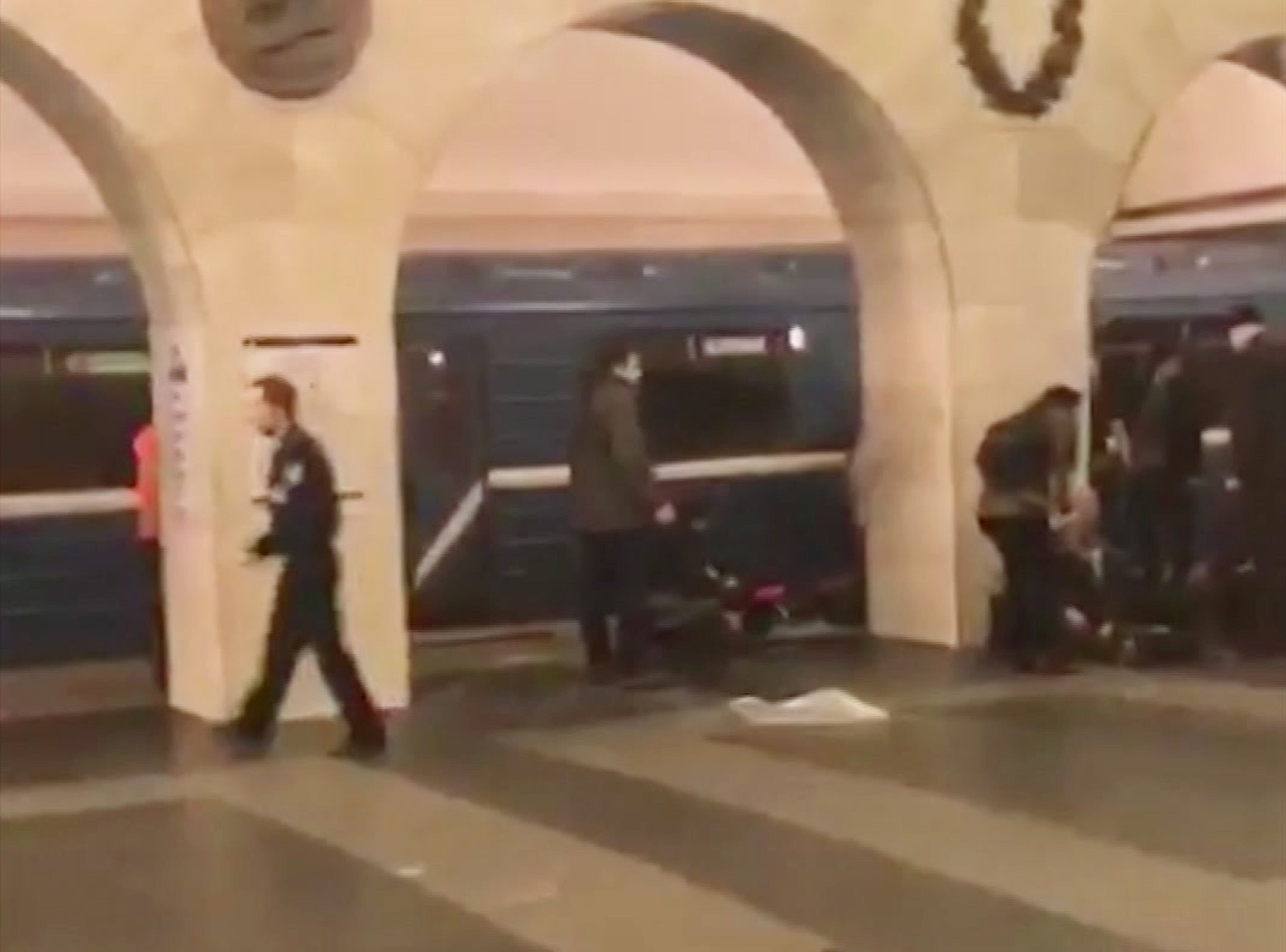 In this image taken from video footage filmed from a moving train on the opposite platform to where the blast occurred, people injured in blast. right, at St. Petersburg's Technological Institute metro station lay on ground, Russia, Monday, April 3, 2017. At least 10 people were killed Monday in an explosion on the subway in St. Petersburg, Russian news agencies reported. (@DARIIIIIINA via AP)