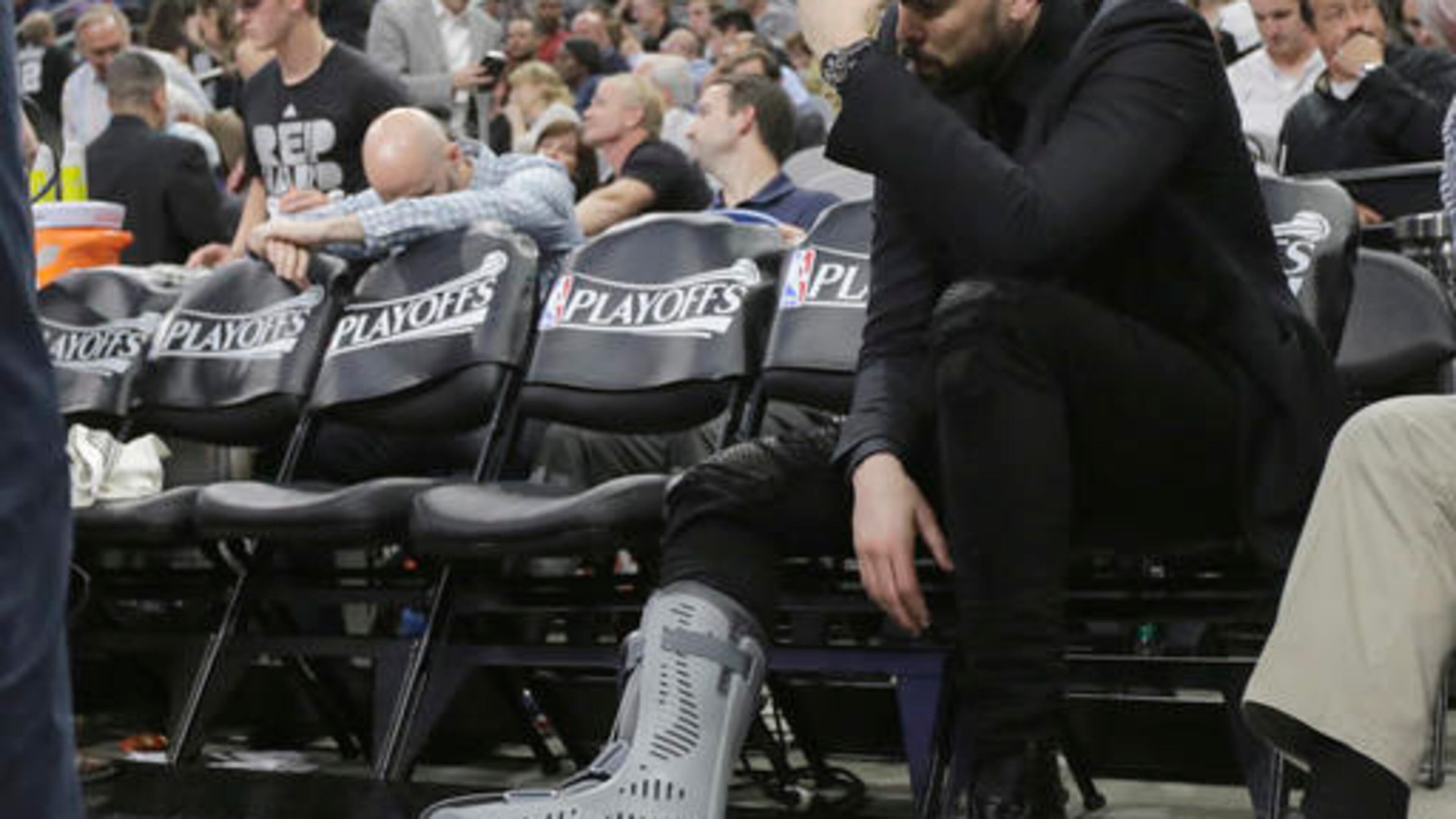 Memphis Grizzlies center Marc Gasol, who is out with a foot injury, sits on the bench during the second half in Game 2 of a first-round NBA basketball playoff series against the San Antonio Spurs, Tuesday, April 19, 2016, in San Antonio. San Antonio won 94-68. (AP Photo/Eric Gay)