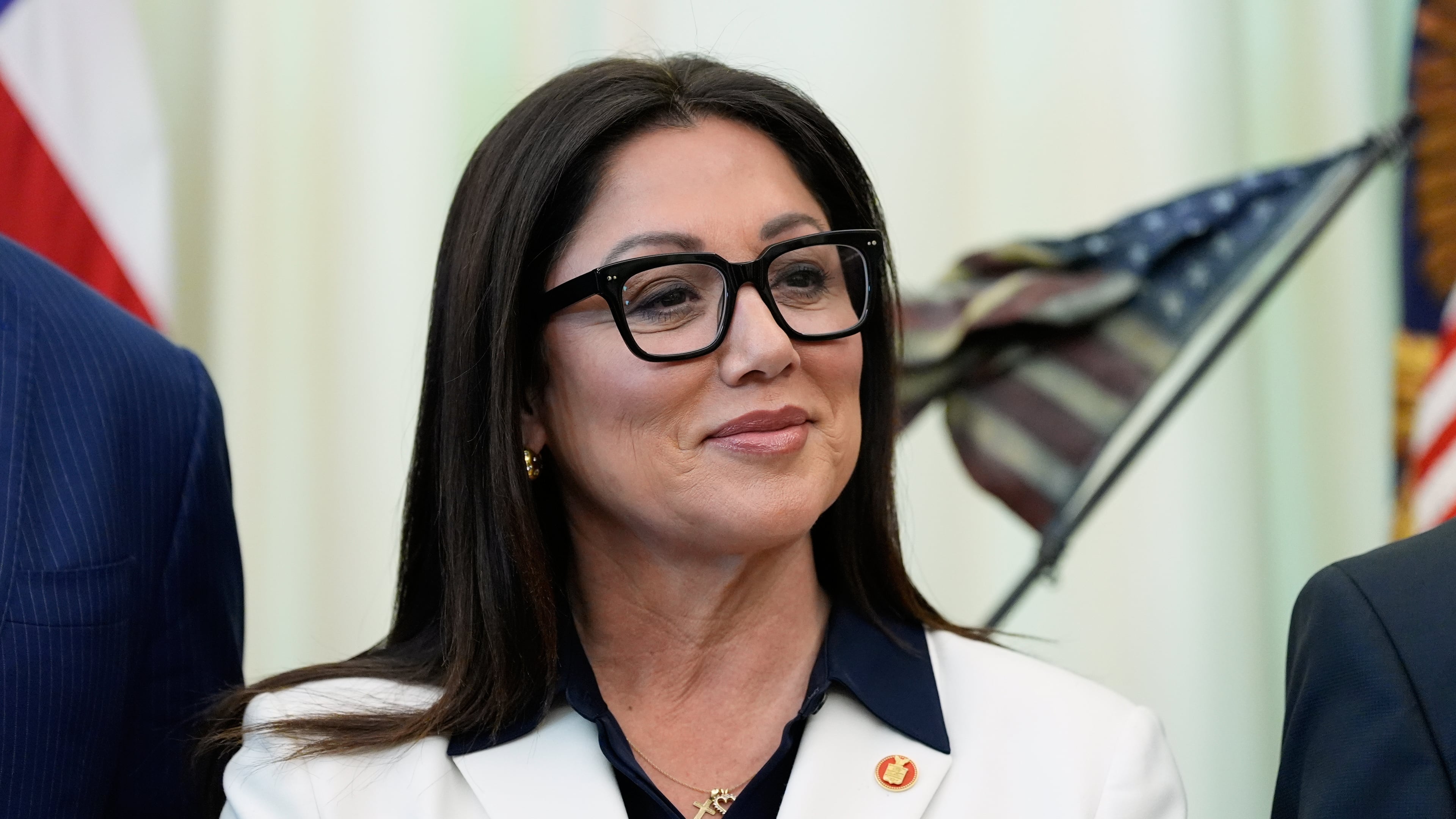 FILE - Labor Secretary Lori Chavez-DeRemer listens as President Donald Trump speaks in the Oval Office of the White House, Oct. 16, 2025, in Washington. (AP Photo/Alex Brandon, File)