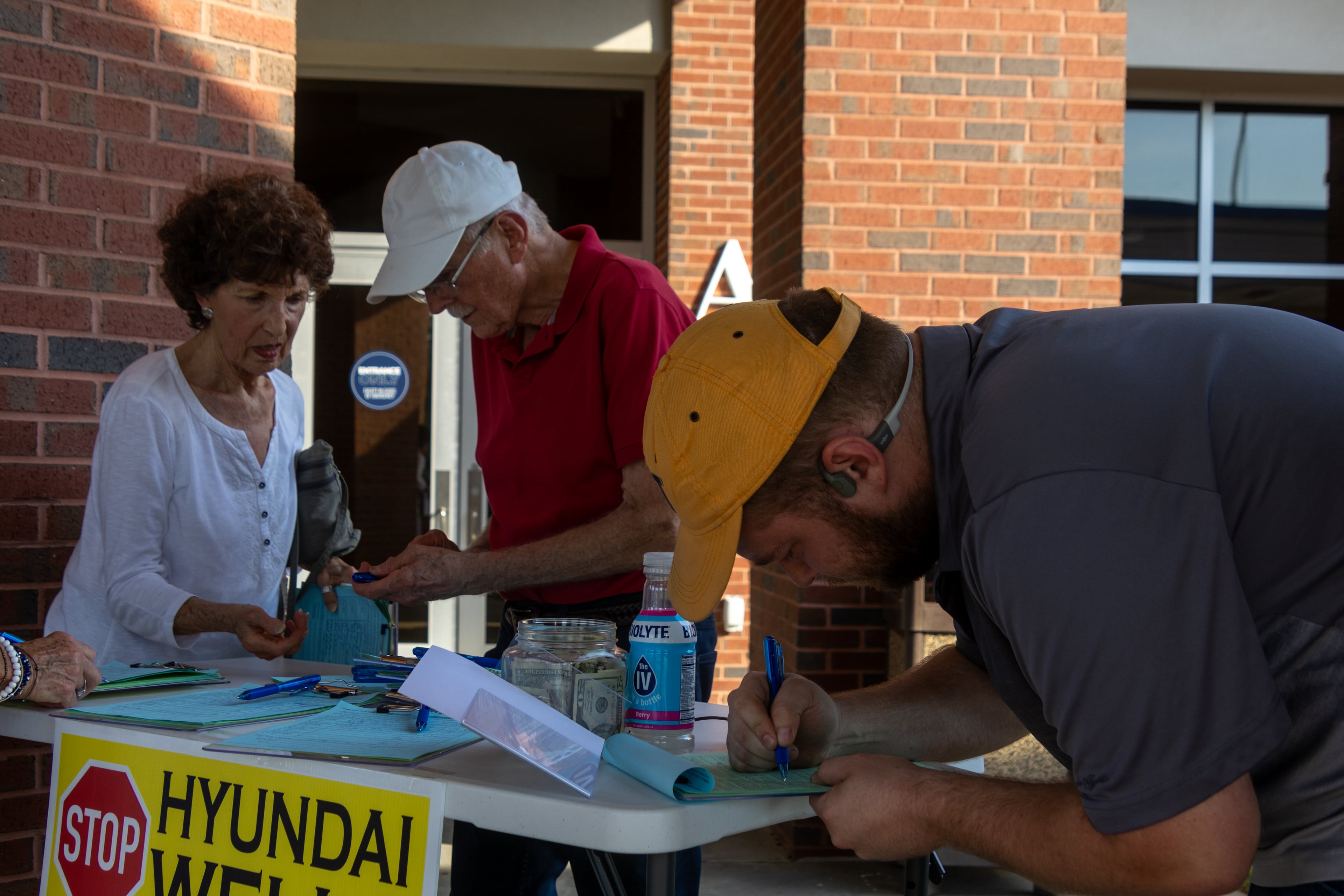 Bulloch County residents sign petitions meant to trigger ballot referendums aimed at stopping the drilling of four groundwater wells to supply water to the Hyundai factory and related development. (Katelyn Myrick/AJC)