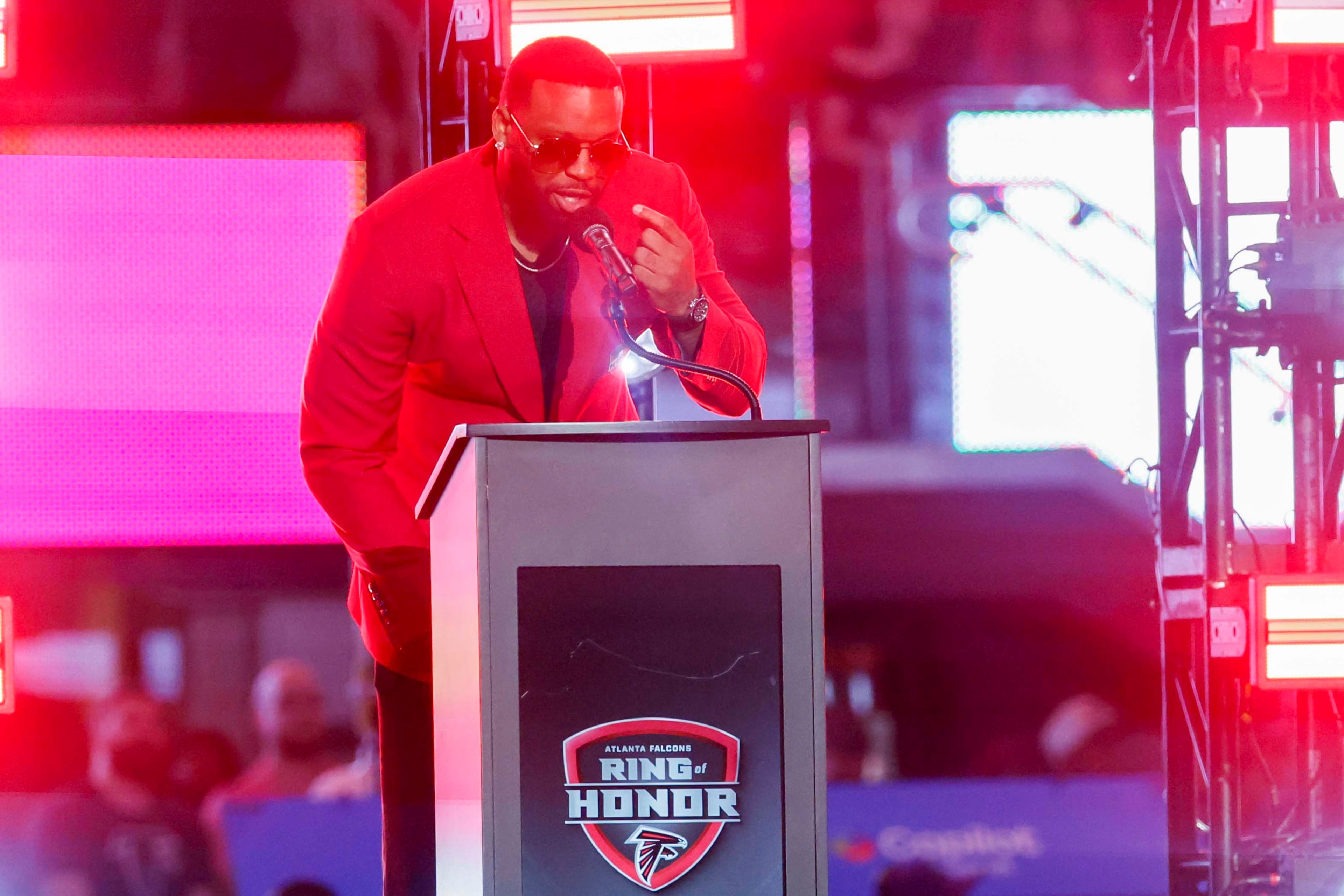 Former Atlanta Falcons defensive end John Abraham addresses the crowd during his Ring of Honor induction ceremony at halftime of an NFL game between the Baltimore Ravens and the Atlanta Falcons at Mercedes-Benz Stadium in Atlanta, GA, Sunday, Oct. 11, 2026. (Miguel Martinez/AJC)