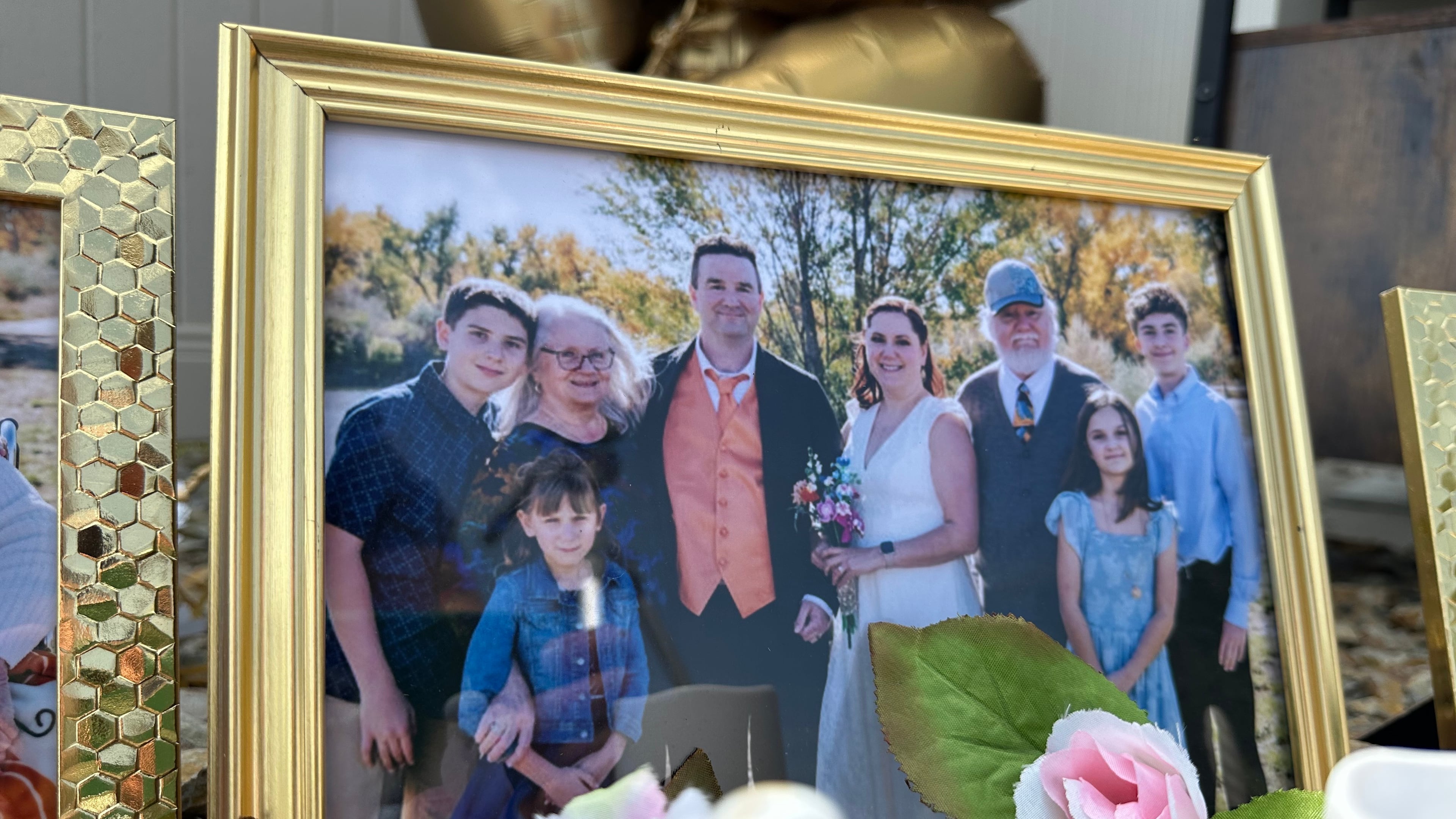 A wedding photo taken by Miranda Murdock that shows relatives who were killed in a home outside Billings, Mont., is displayed at a memorial site on Wednesday, Aug. 26, 2026. (AP Photo/Matthew Brown)