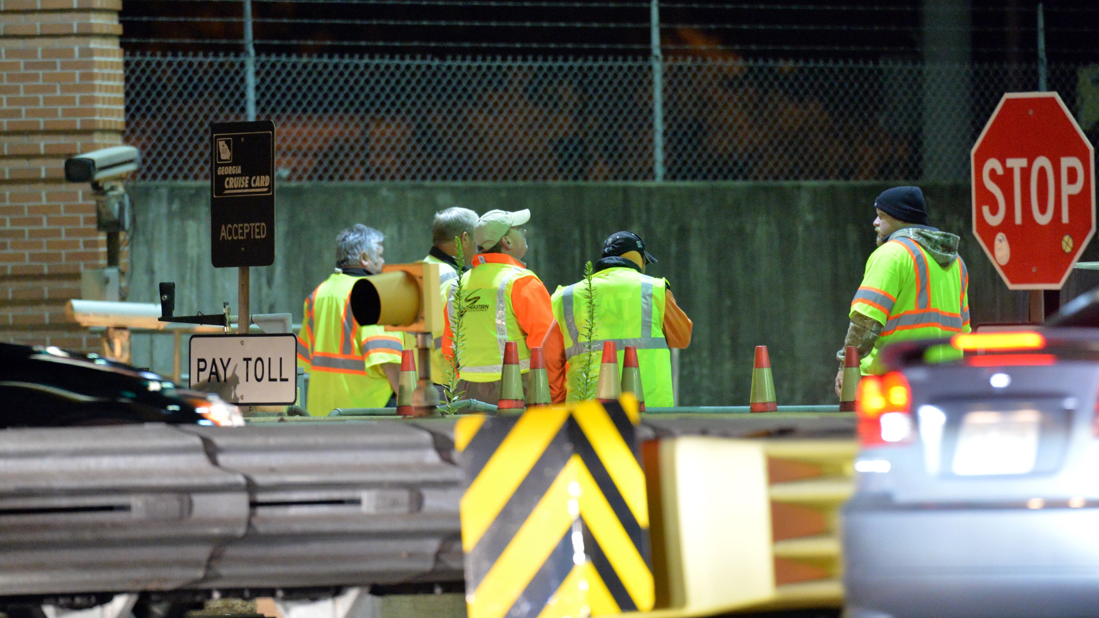 Road crews work as Georgia Department of Transportation closes two northbound lanes near Georgia 400 toll booths on Oct. 25, 2013. HYOSUB SHIN / HSHIN@AJC.COM