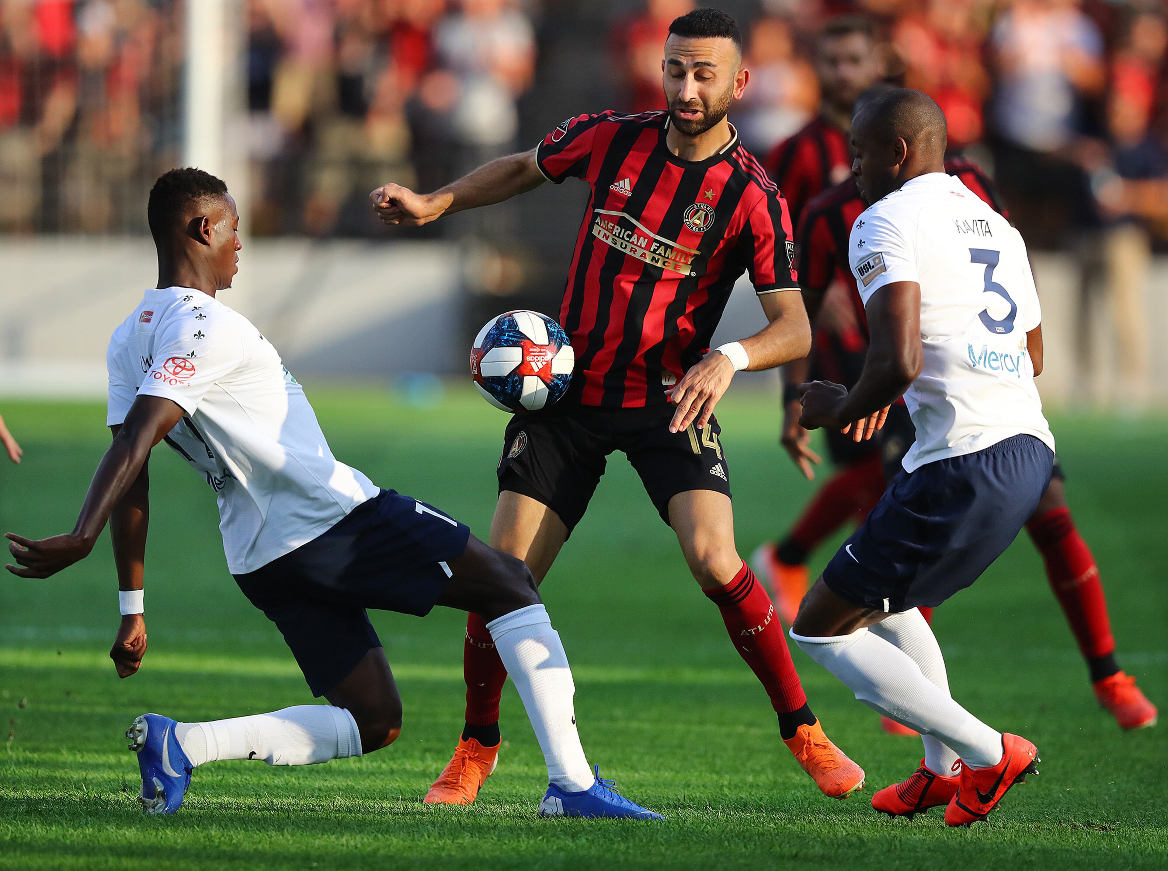 Atlanta United's Justin Meram (middle) defends against St. Louis players Oscar Umar (left) and Phanuel Kavita. Curtis Compton/ccompton@ajc.com