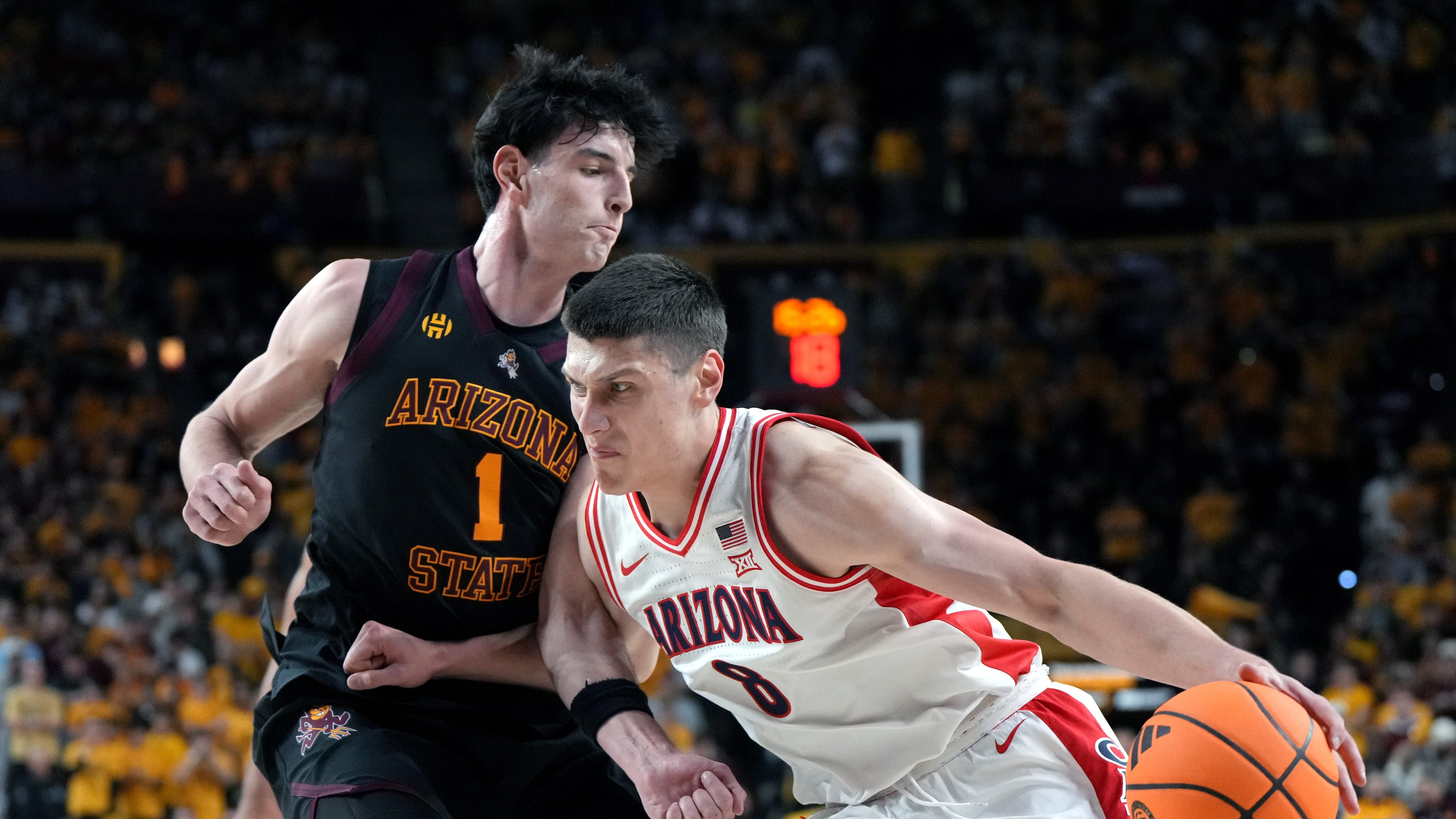 Arizona forward Ivan Kharchenkov (8) drives on Arizona State forward Santiago Trouet during the first half of an NCAA college basketball game, Saturday, Jan. 31, 2026, in Tempe, Ariz. (AP Photo/Rick Scuteri)