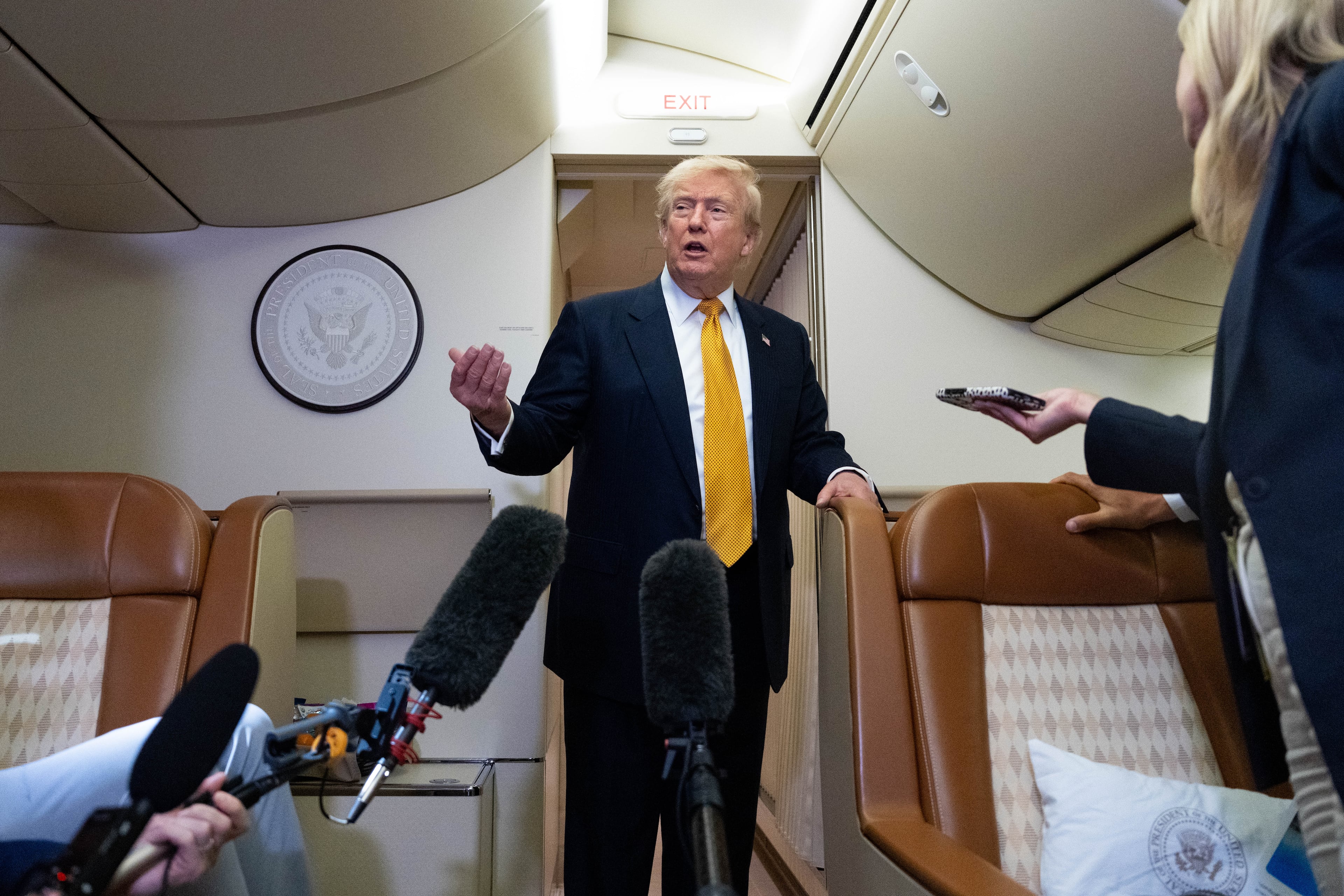 President Donald Trump speaks with reporters on Air Force One after landing in Suffolk, Eastern England, last Wednesday. (Alex Brandon/AP)