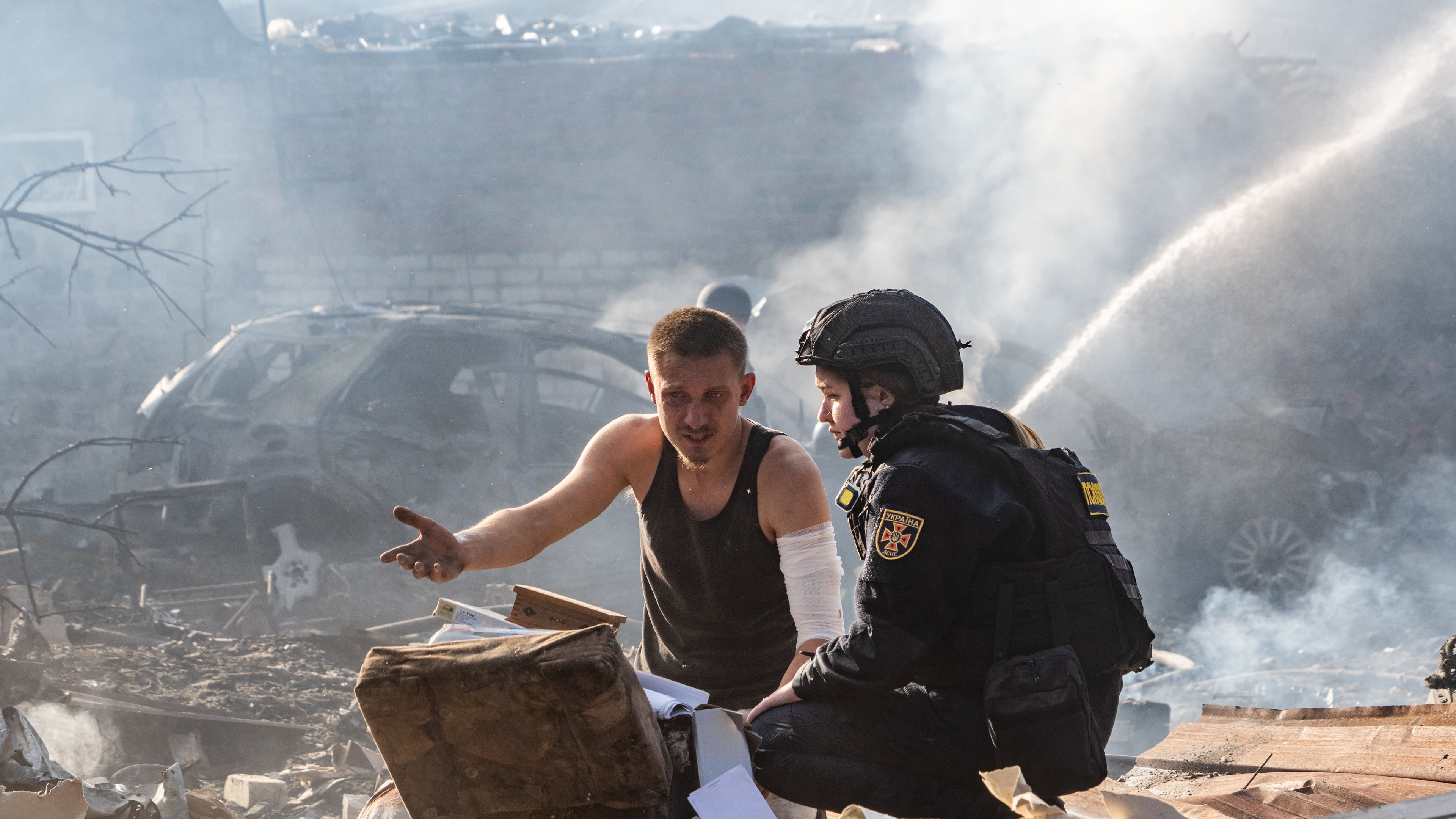 An injured man collects his personal belongings in front of his house destroyed in a Russian strike on Kharkiv, Ukraine, Sunday, Oct. 11, 2026. (AP Photo/Andrii Marienko)