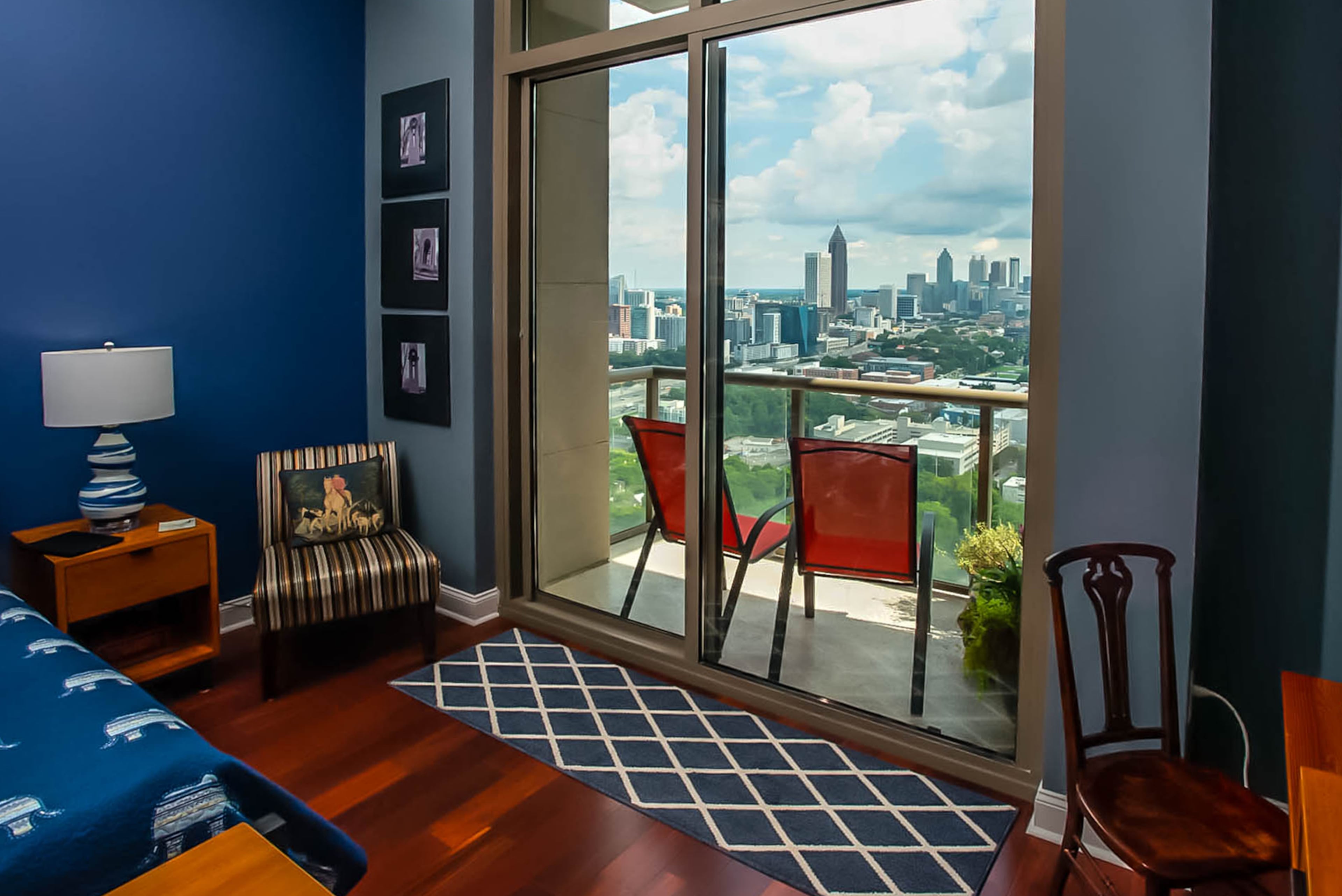 Out from the master bedroom, a balcony provides another view of the evolving Atlanta skyline. Walls painted blue envelop the space.