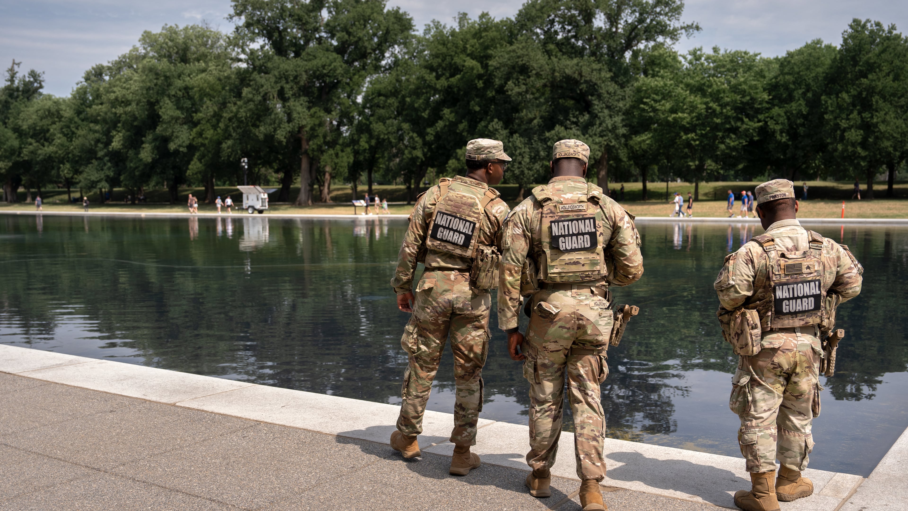 National Guard members look at the Lincoln Memorial Reflecting Pool, Monday, June 22, 2026, in Washington. (AP Photo/Mark Schiefelbein)