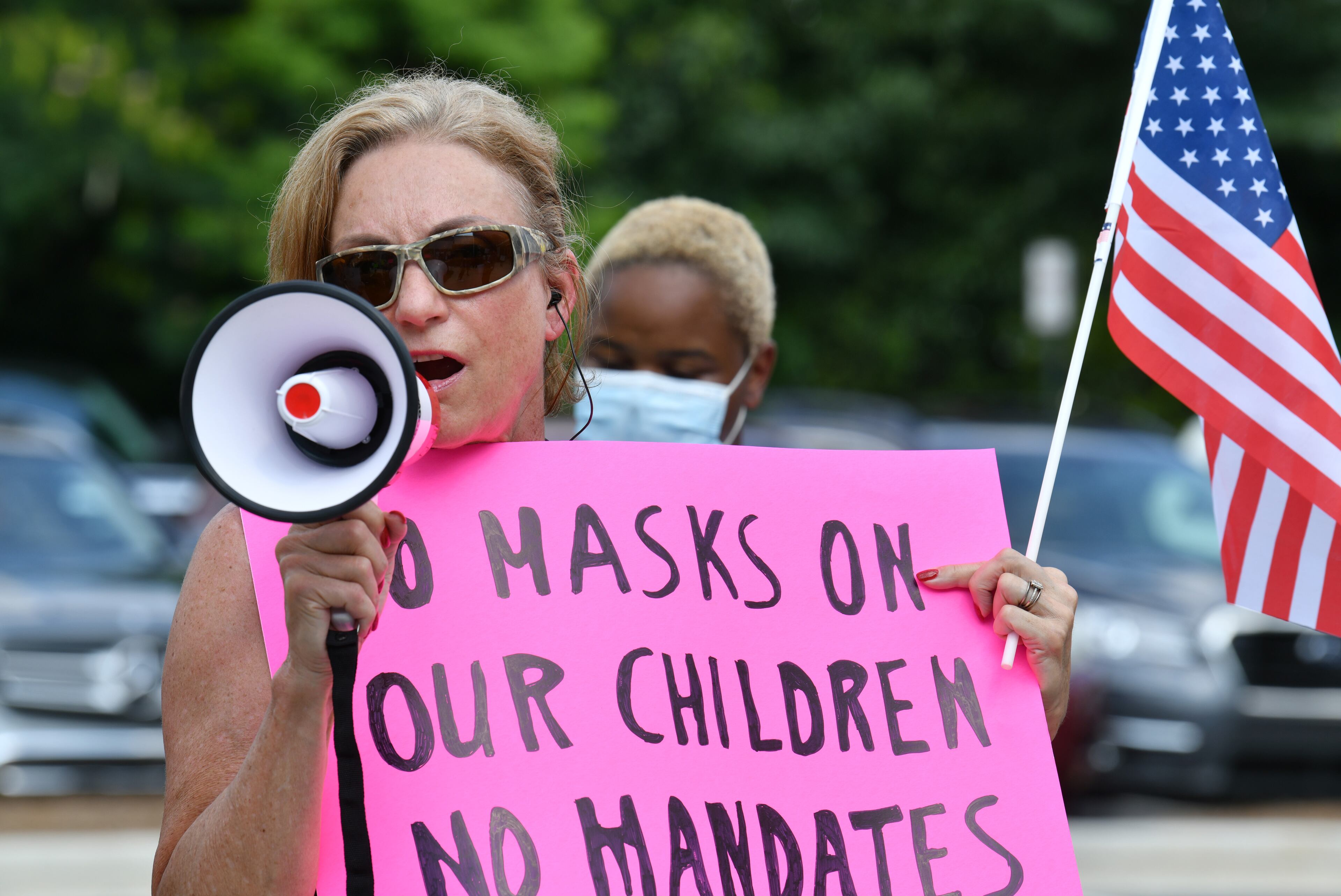 Parents gathered at the headquarters of the Cobb County School District on Aug. 12, 2021, to call for a mask mandate in schools. People who oppose masks in schools also turned out. (Hyosub Shin / Hyosub.Shin@ajc.com)