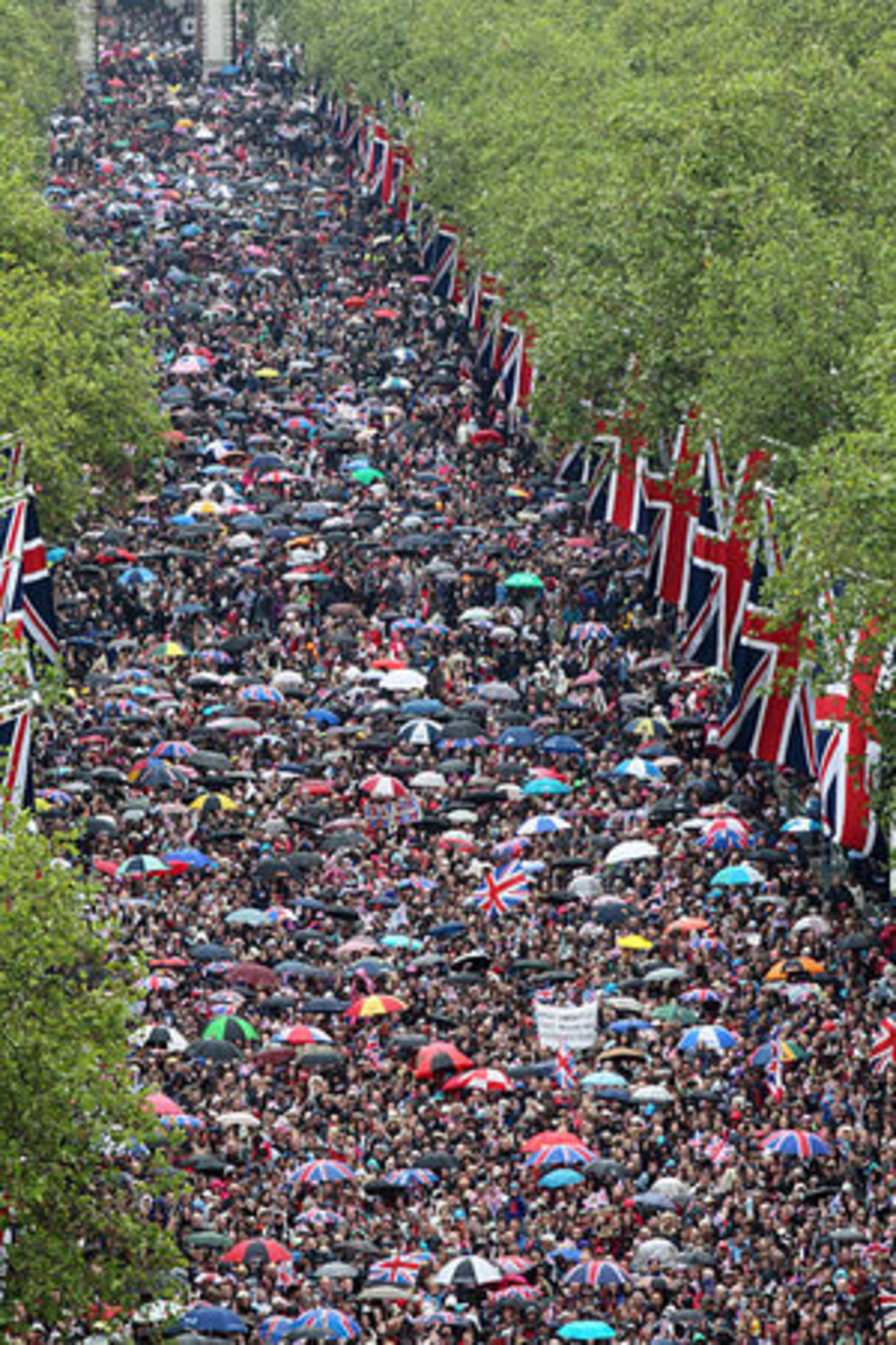 Crowds walk on the Mall on the way to Buckingham Palace in London to celebrate Queen Elizabeth's Diamond Jubilee as the royal family stood on the balcony Tuesday June 5, 2012.