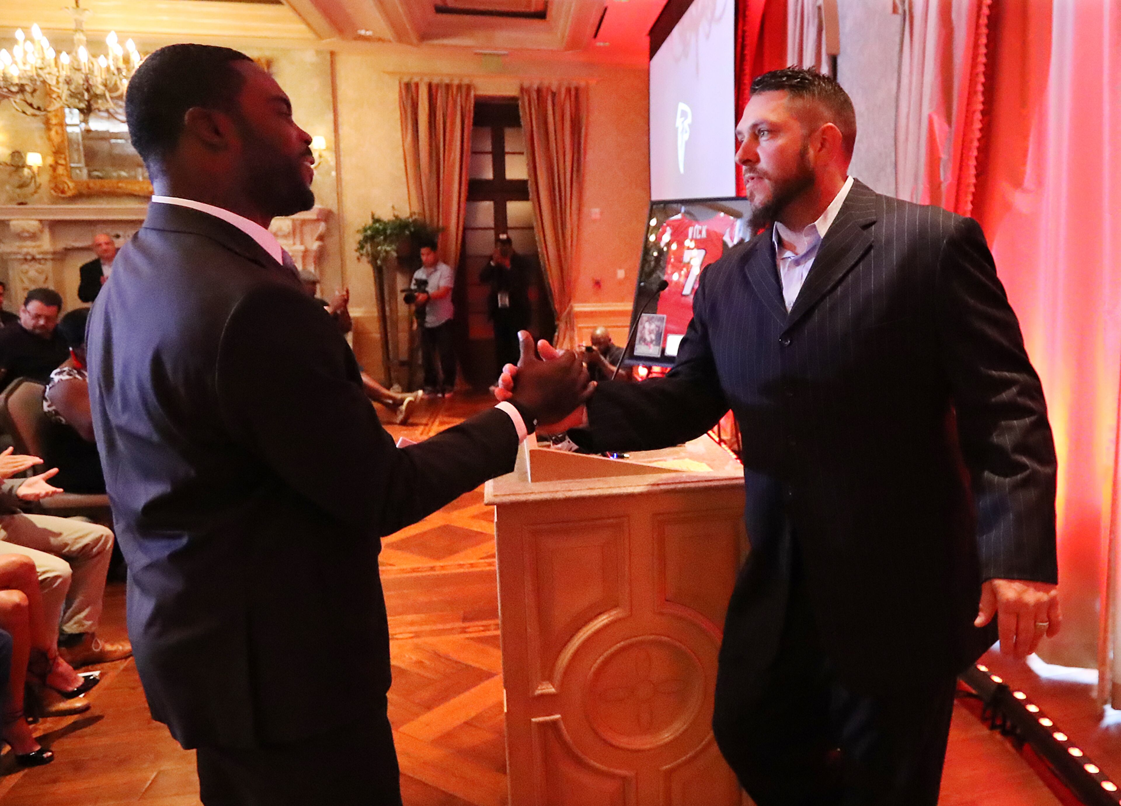 Former center Todd McClure introduces Michael Vick as the Atlanta Falcons honor the former Falcons quarterback and wide receiver Roddy White as they officially retire from the NFL on Monday, June 12, 2017, in Atlanta.