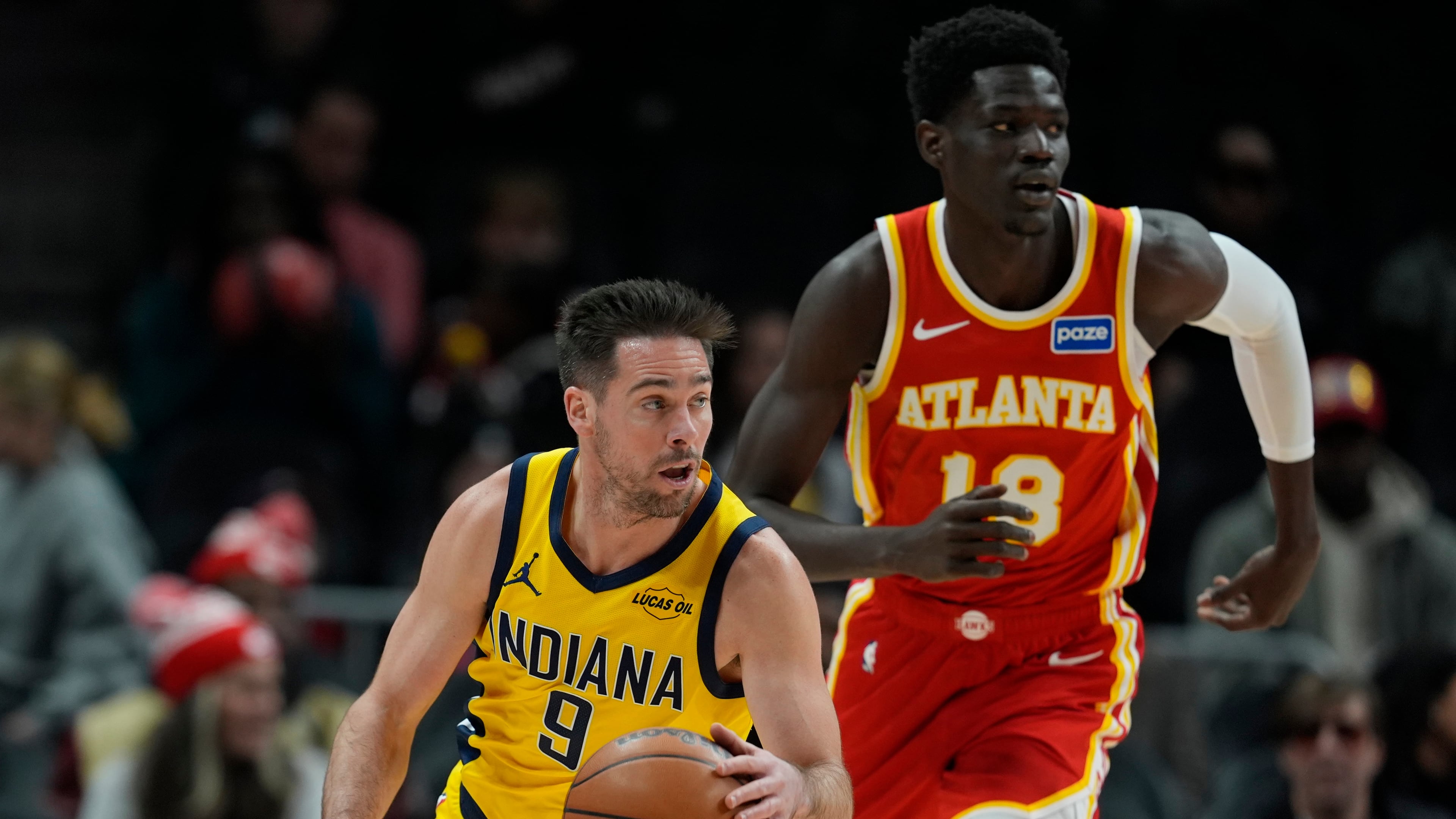 Indiana Pacers guard T.J. McConnell (9) moves against Atlanta Hawks forward Mouhamed Gueye (18) during the first half of an NBA basketball game, Monday, Jan. 26, 2026, in Atlanta. (AP Photo/Mike Stewart)