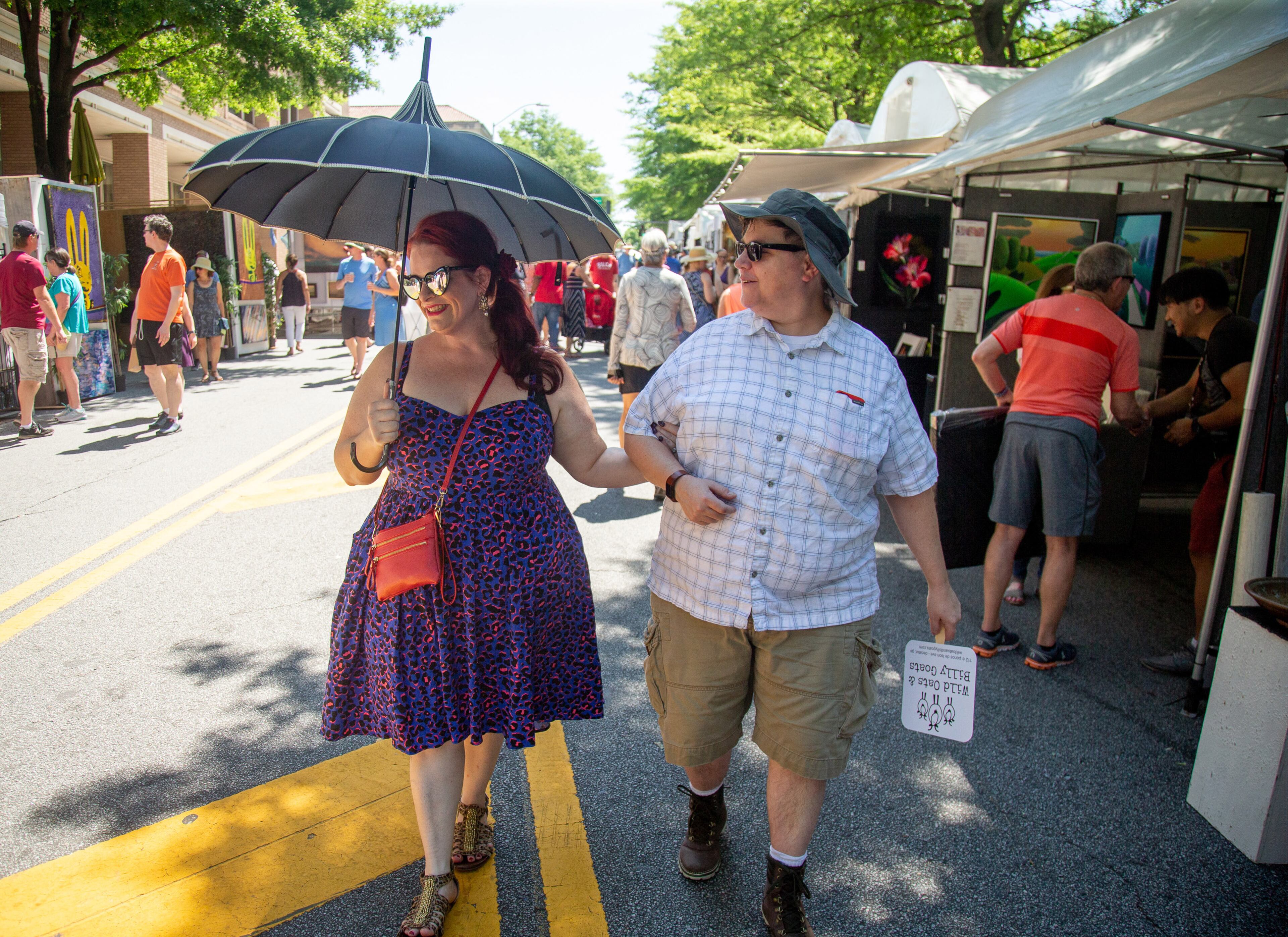 Angie Dykes,L, and Jan Dykes walk past the artist booth during the annual Decatur Arts Festival on Sunday, May 26, 2019. STEVE SCHAEFER / SPECIAL TO THE AJC