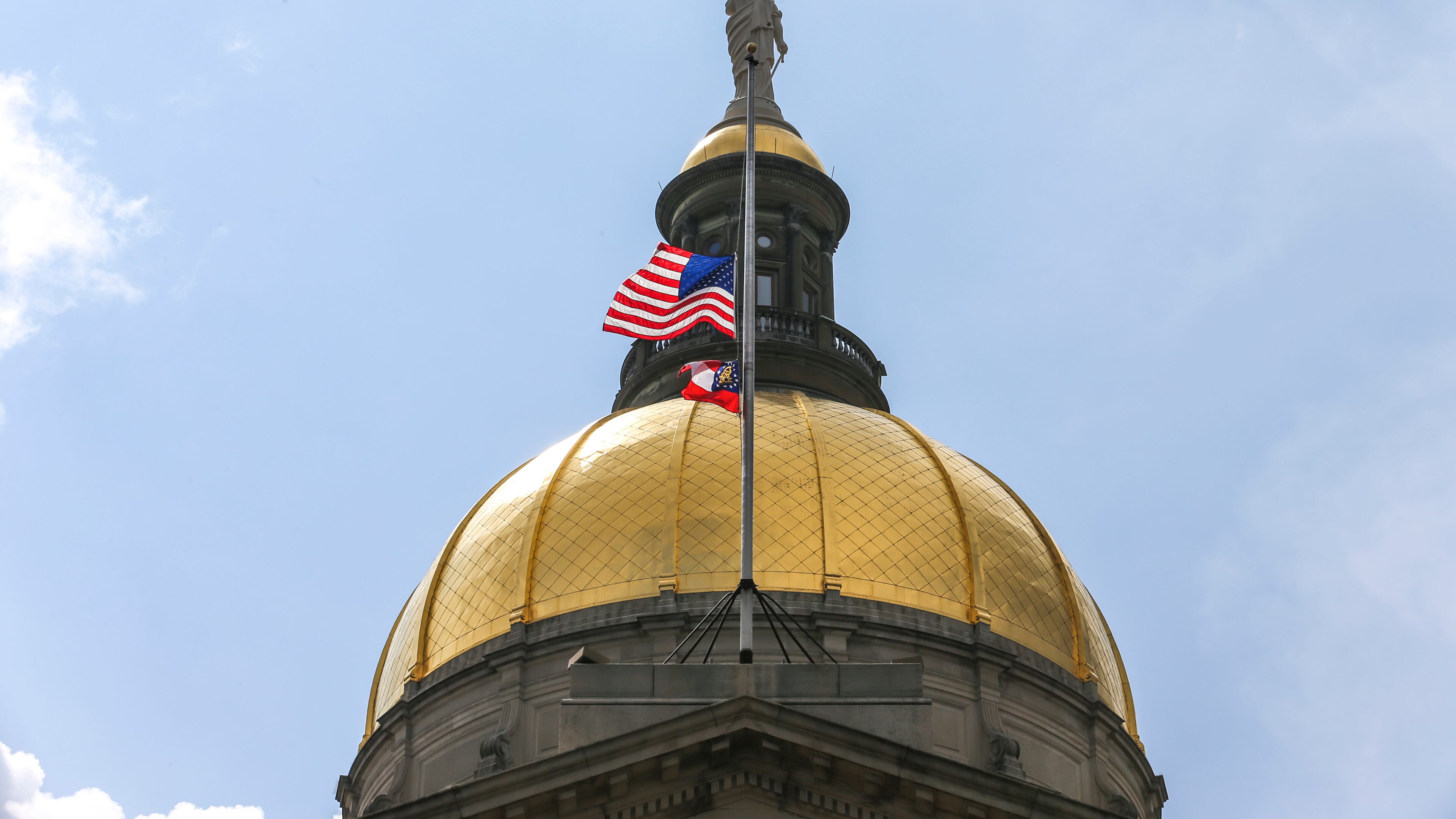 July 11, 2019 Atlanta : The United States and State of Georgia flags flew half-staff at the Georgia State Capitol on Thursday July 11, 2019 after Governor Kemp signed an executive order in memory of Hall County deputy Nicolas Dixon who was shot and killed. JOHN SPINK/JSPINK@AJC.COM