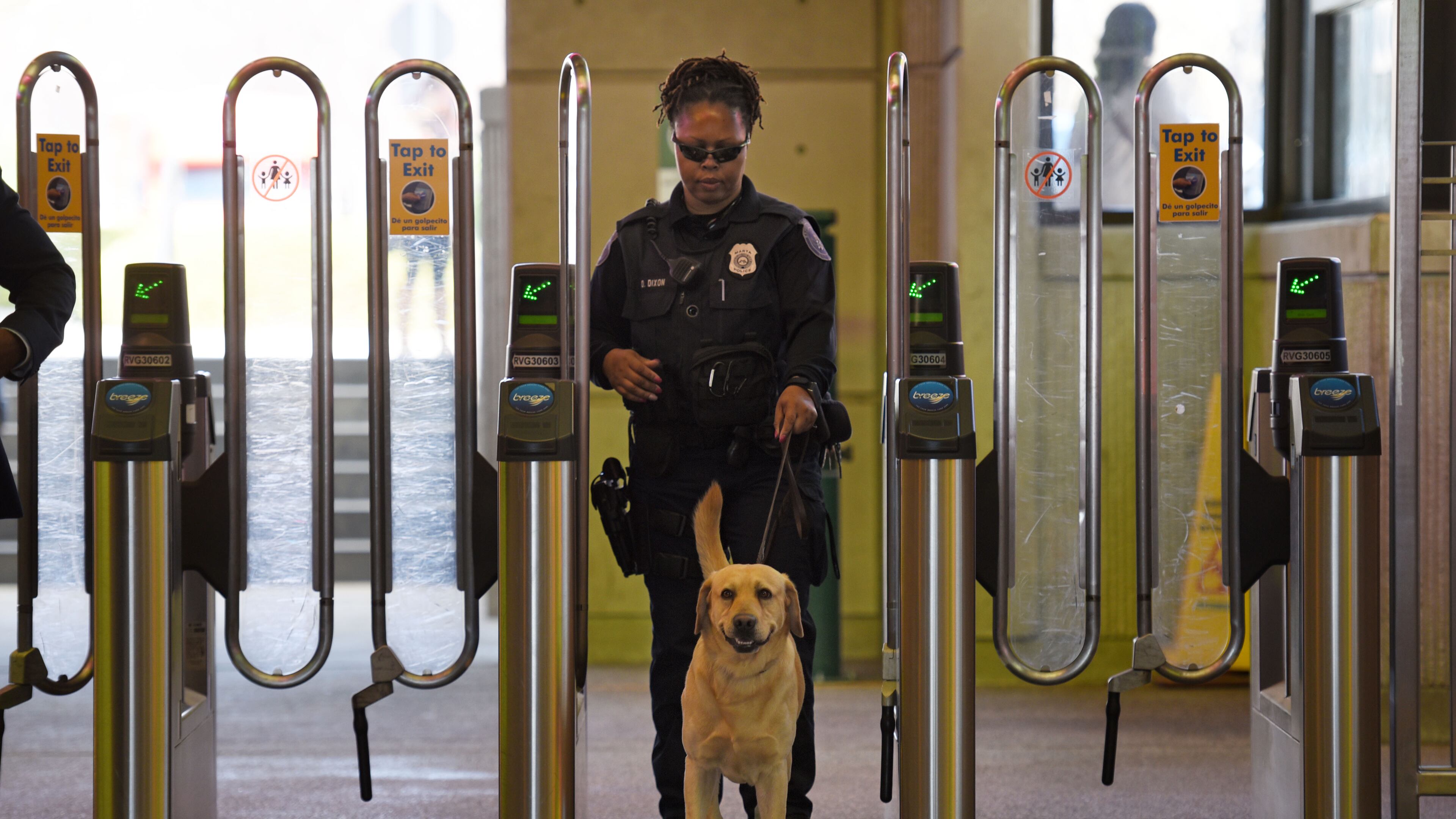 MARTA police K-9 handler Deidre Dixon guides her K-9 dog at the Lindbergh Center MARTA station in a file photo.