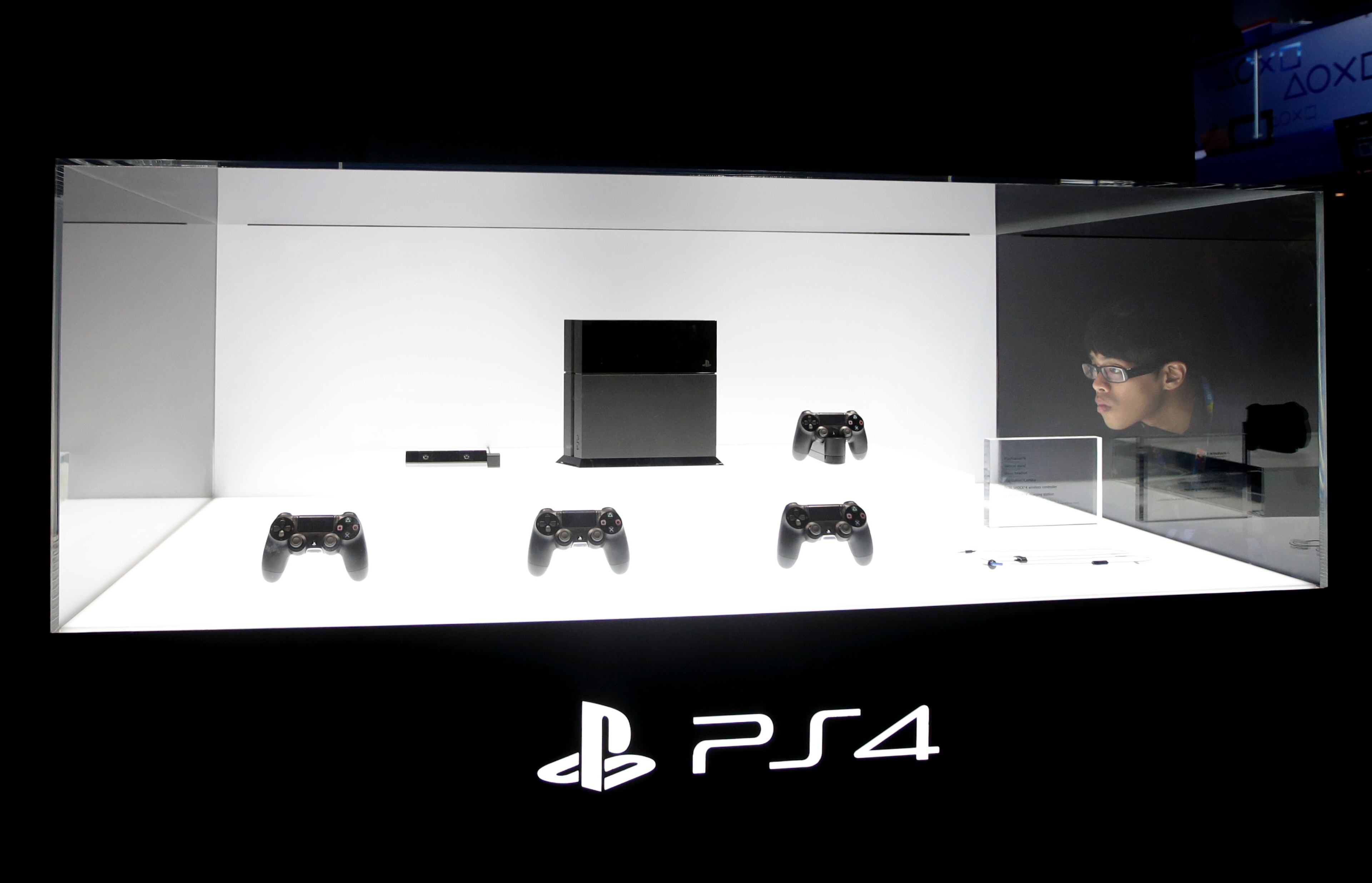 A show attendee looks at the new PlayStation 4 at the Sony booth during the Electronic Entertainment Expo in Los Angeles, Tuesday, June 11, 2013. (AP Photo/Jae C. Hong)