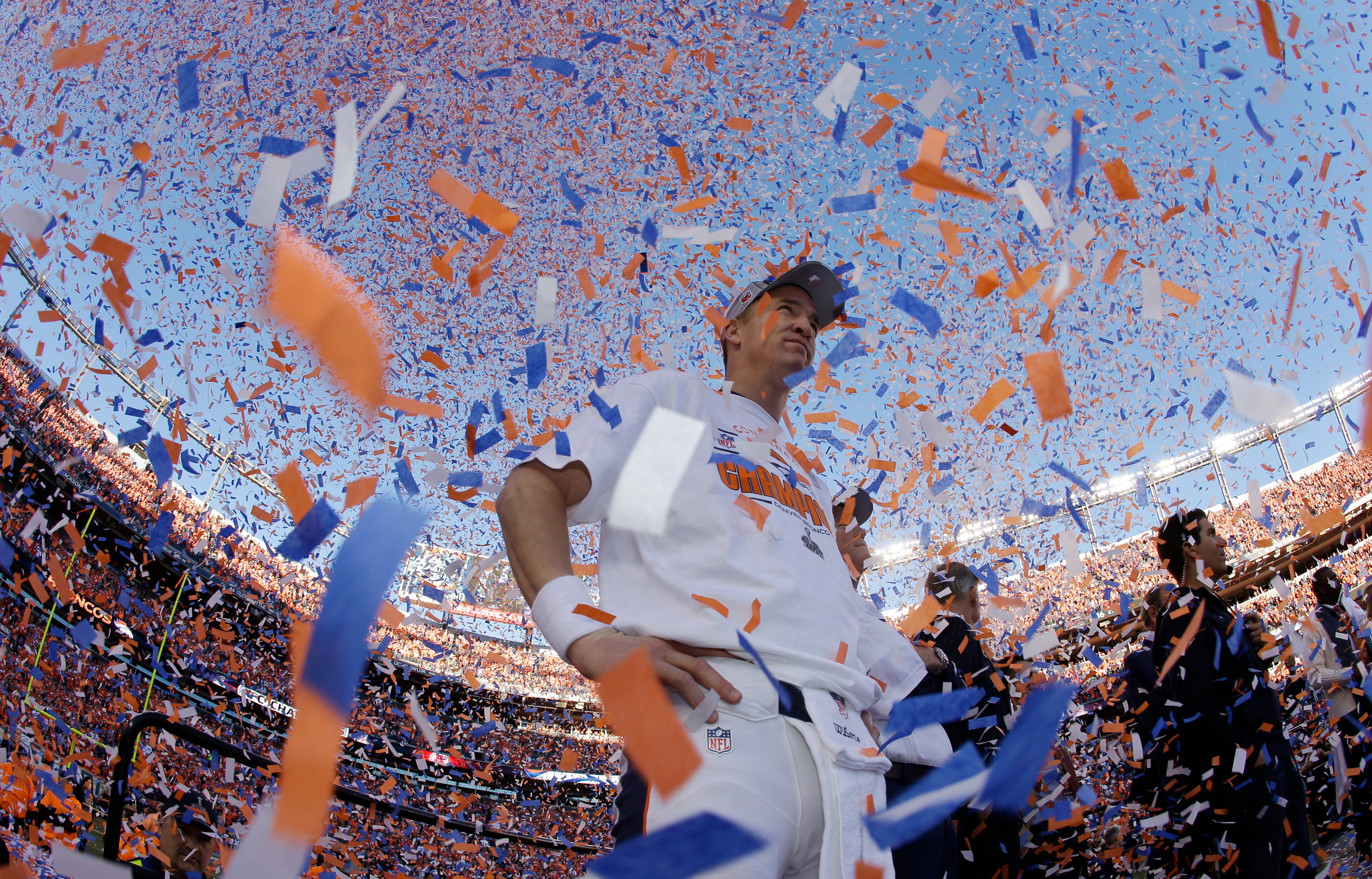 Denver Broncos quarterback Peyton Manning is engulfed in confetti during the trophy ceremony after the AFC Championship NFL playoff football game in Denver, Sunday, Jan. 19, 2014. The Broncos defeated the Patriots 26-16 to advance to the Super Bowl. (AP Photo/Charlie Riedel)