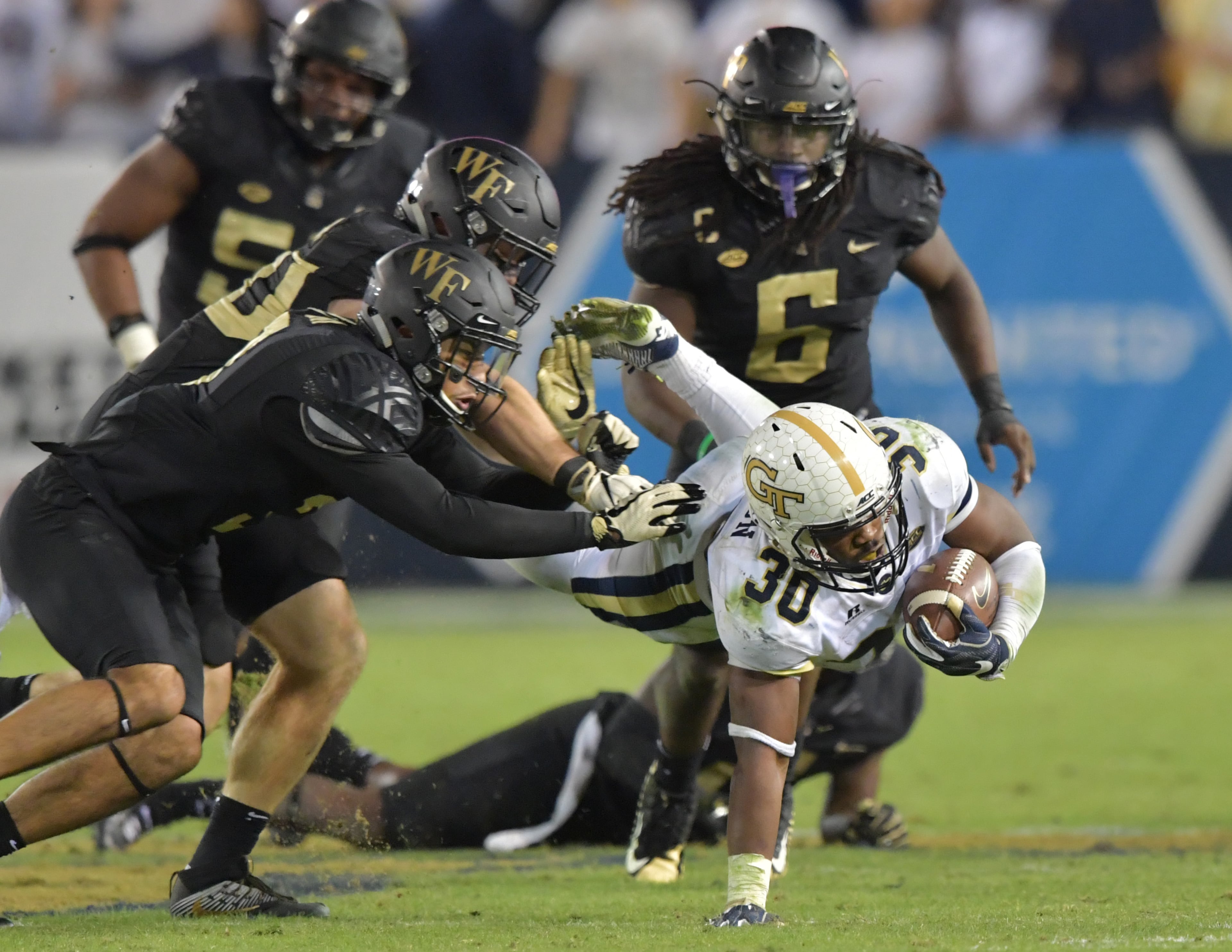 October 21, 2017 Atlanta -Georgia Tech running back KirVonte Benson (30) dives for yardage in the second half of an NCAA college football game at Bobby Dodd Stadium on Saturday, October 21, 2017. Georgia Tech beat Wake Forest 38-24. HYOSUB SHIN / HSHIN@AJC.COM