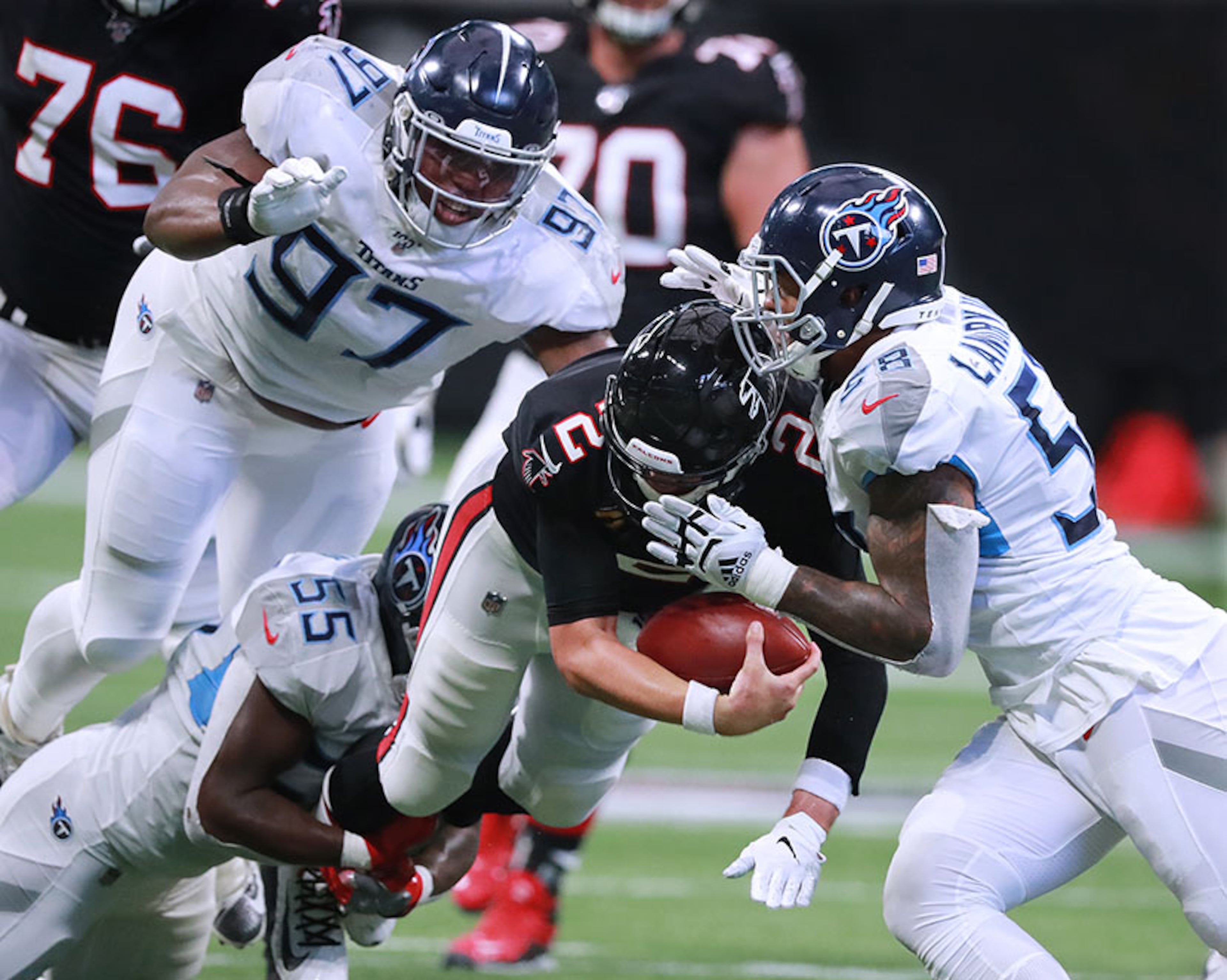 Falcons quarterback Matt Ryan is tackled by Tennessee defenders Jayon Brown (from left), Isaiah Mack and Harold Landy III on a fourth down attempt in the final quarter of a 24-10 loss Sunday, Sept. 29, 2019, at Mercedes-Benz Stadium in Atlanta.