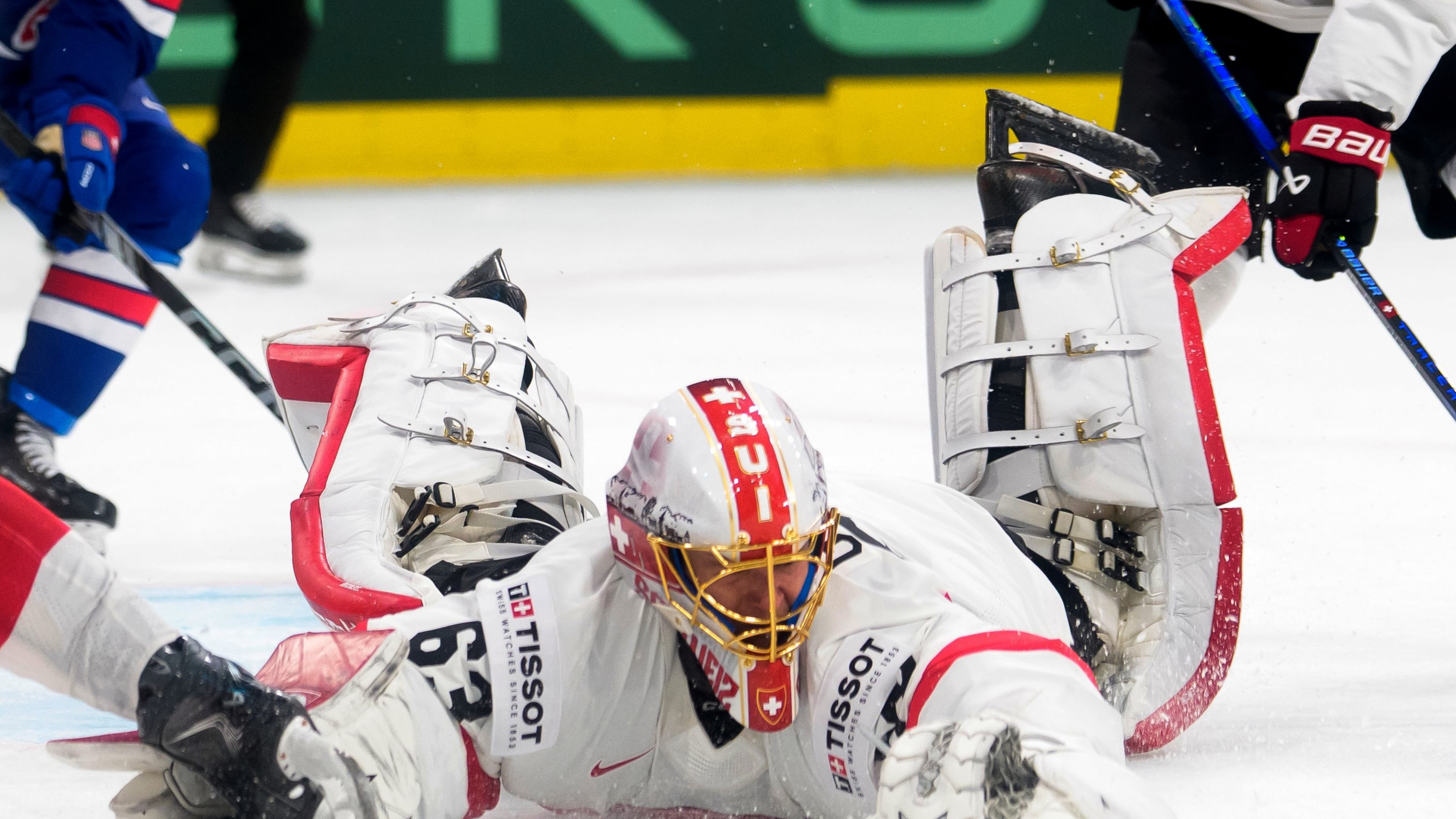 Switzerland's goaltender Leonardo Genoni reaches for the puck during a Group A preliminary round game between United States and Switzerland at the men's ice hockey world championship in Zurich, Switzerland, Friday, May 15, 2026. (Claudio Thoma/Keystone via AP)