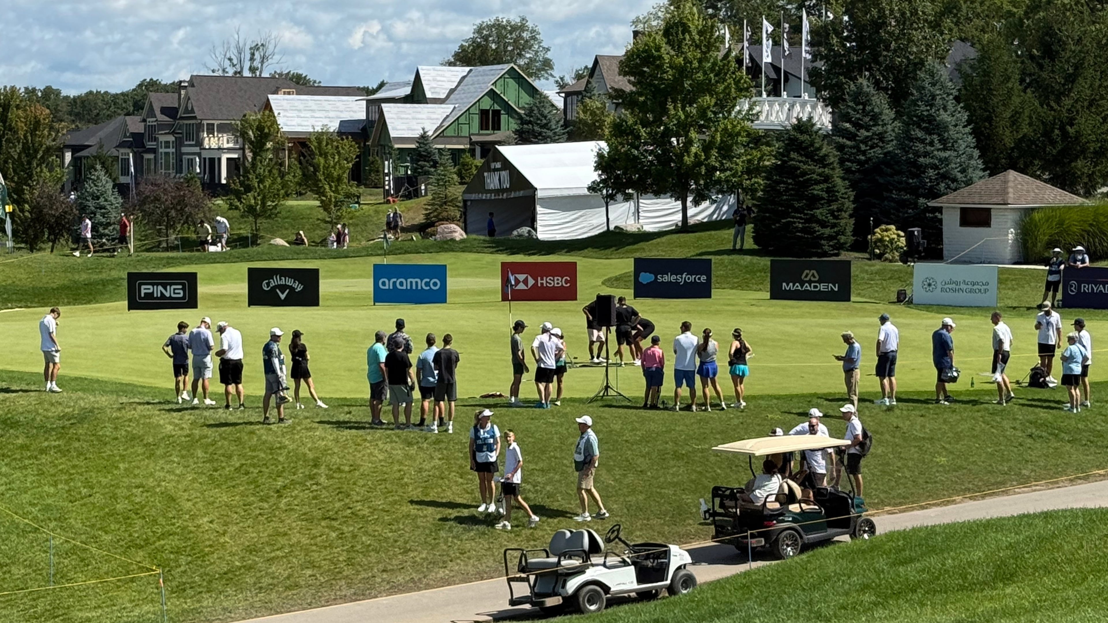 LIV Golf fans gather at the practice putting green before the final round of the season-ending event in suburban Indianapolis, Ind., Sunday, Aug. 23, 2026. (AP Photo/Michael Marot)
