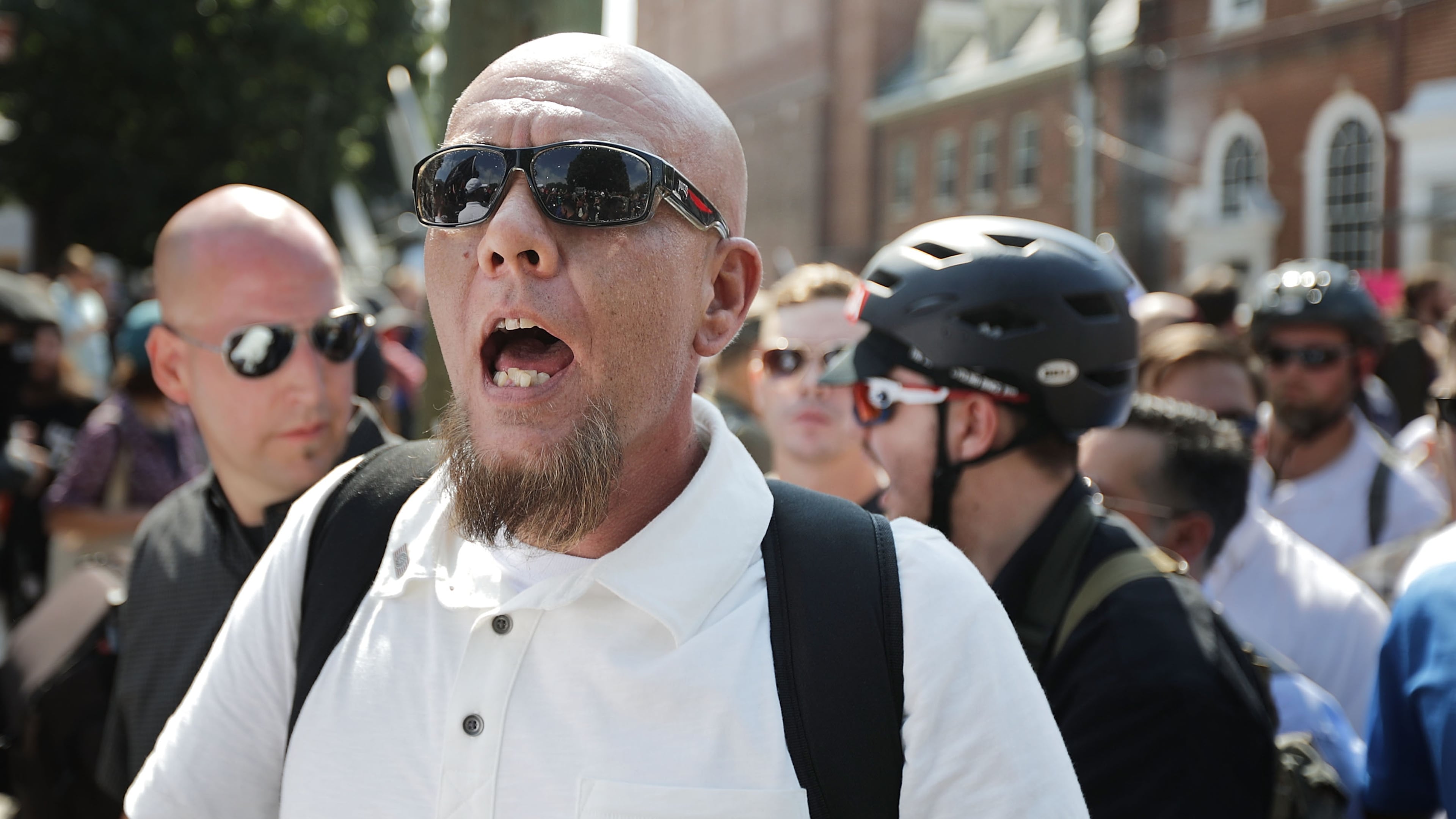 CHARLOTTESVILLE, VA - AUGUST 12: White nationalists, neo-Nazis and members of the "alt-right" exchange insults with counter-protesters as they enter Emancipation Park during the "Unite the Right" rally August 12, 2017 in Charlottesville, Virginia. After clashes with anti-fascist protesters and police the rally was declared an unlawful gathering and people were forced out of Emancipation Park, where a statue of Confederate General Robert E. Lee is slated to be removed. (Photo by Chip Somodevilla/Getty Images)