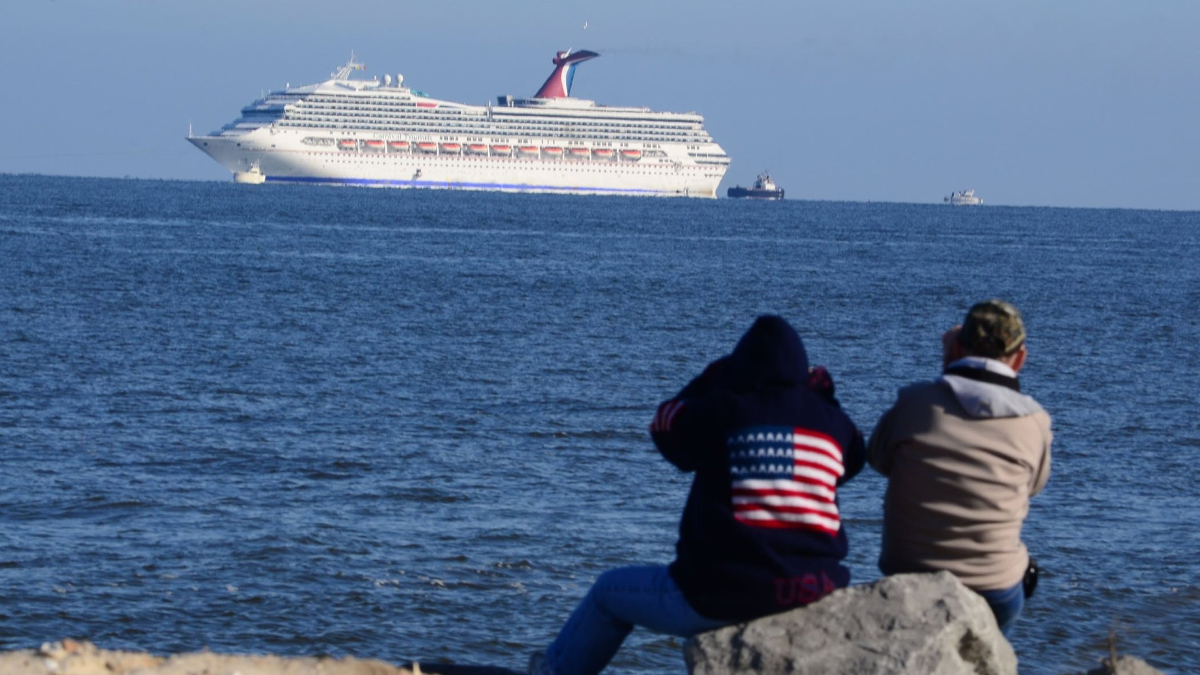Feb. 14, 2013 - Mobile, Alabama, U.S. - People watch from Dauphin Island, Alabama, as the crippled Carnival cruise liner Triumph sits at the mouth of Mobile Bay on February 14, 2013. (Michael E. Palmer/Zuma Press/TNS)